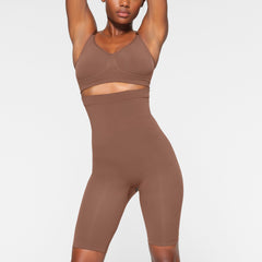 SEAMLESS SCULPT HIGH-WAISTED ABOVE THE KNEE SHORT WORN BY A MODEL IN FRONT VIEW 