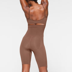 SEAMLESS SCULPT HIGH-WAISTED ABOVE THE KNEE SHORT ON A MODEL BACK VIEW