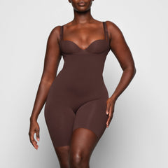 BUTT ENHANCING OPEN BUST BODYSUIT WORN BY A MODEL IN FRONT VIEW, XL