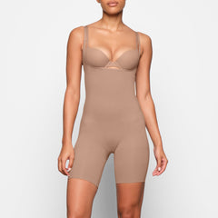 BUTT ENHANCING OPEN BUST BODYSUIT WORN BY A MODEL IN FRONT VIEW 