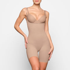 BUTT ENHANCING OPEN BUST BODYSUIT ON A MODEL BACK VIEW