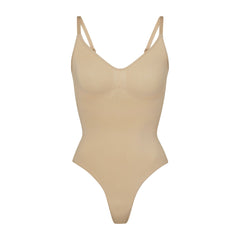 SEAMLESS SCULPT THONG BODYSUIT | CLAY (SHAPEWEAR BODYSUITS) LAYS FLAT ON A WHITE BACKGROUND | FLT
