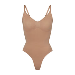 SEAMLESS SCULPT THONG BODYSUIT | SIENNA (SHAPEWEAR BODYSUITS) LAYS FLAT ON A WHITE BACKGROUND | FLT