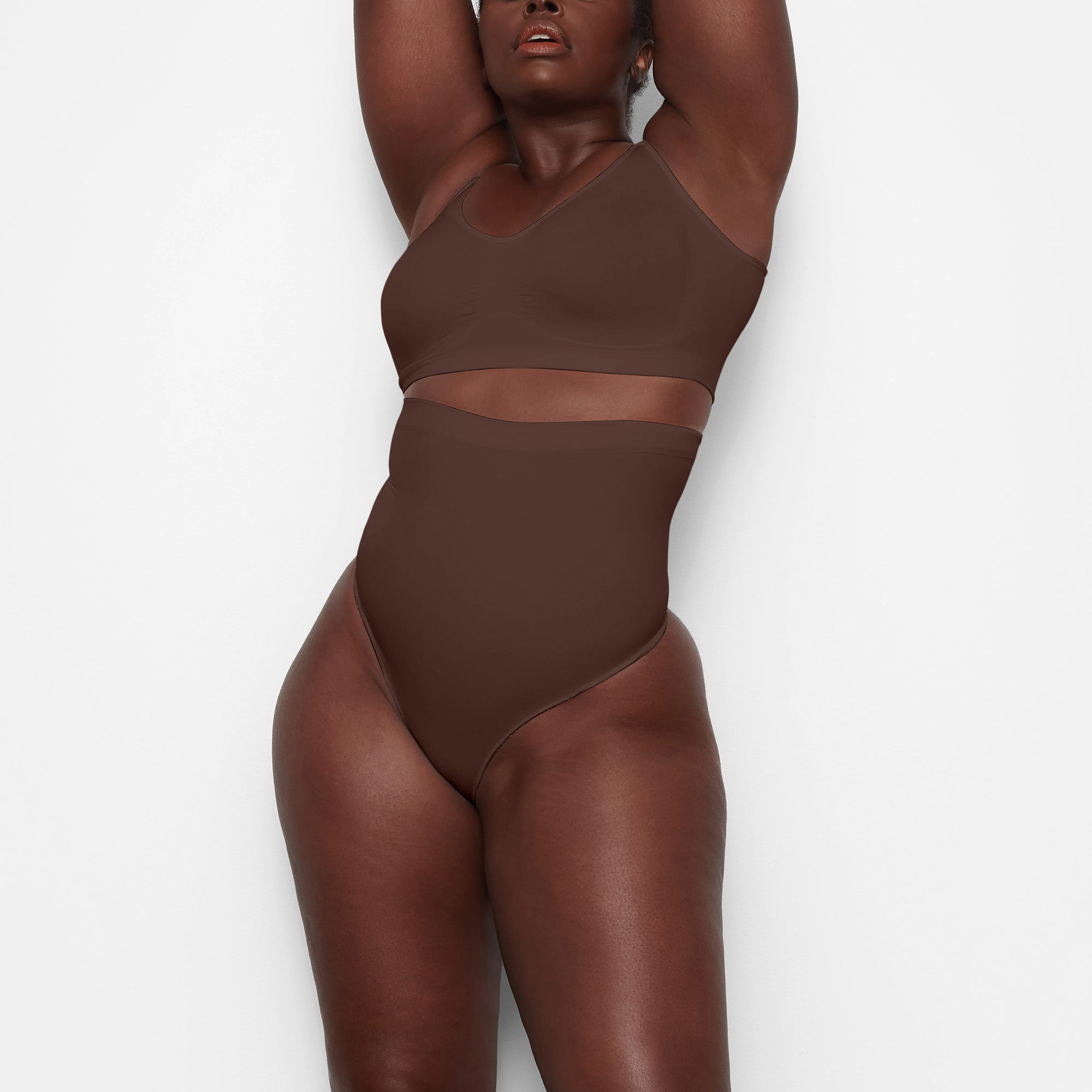SEAMLESS SCULPT HIGH-WAISTED THONG WORN BY A MODEL IN FRONT VIEW 