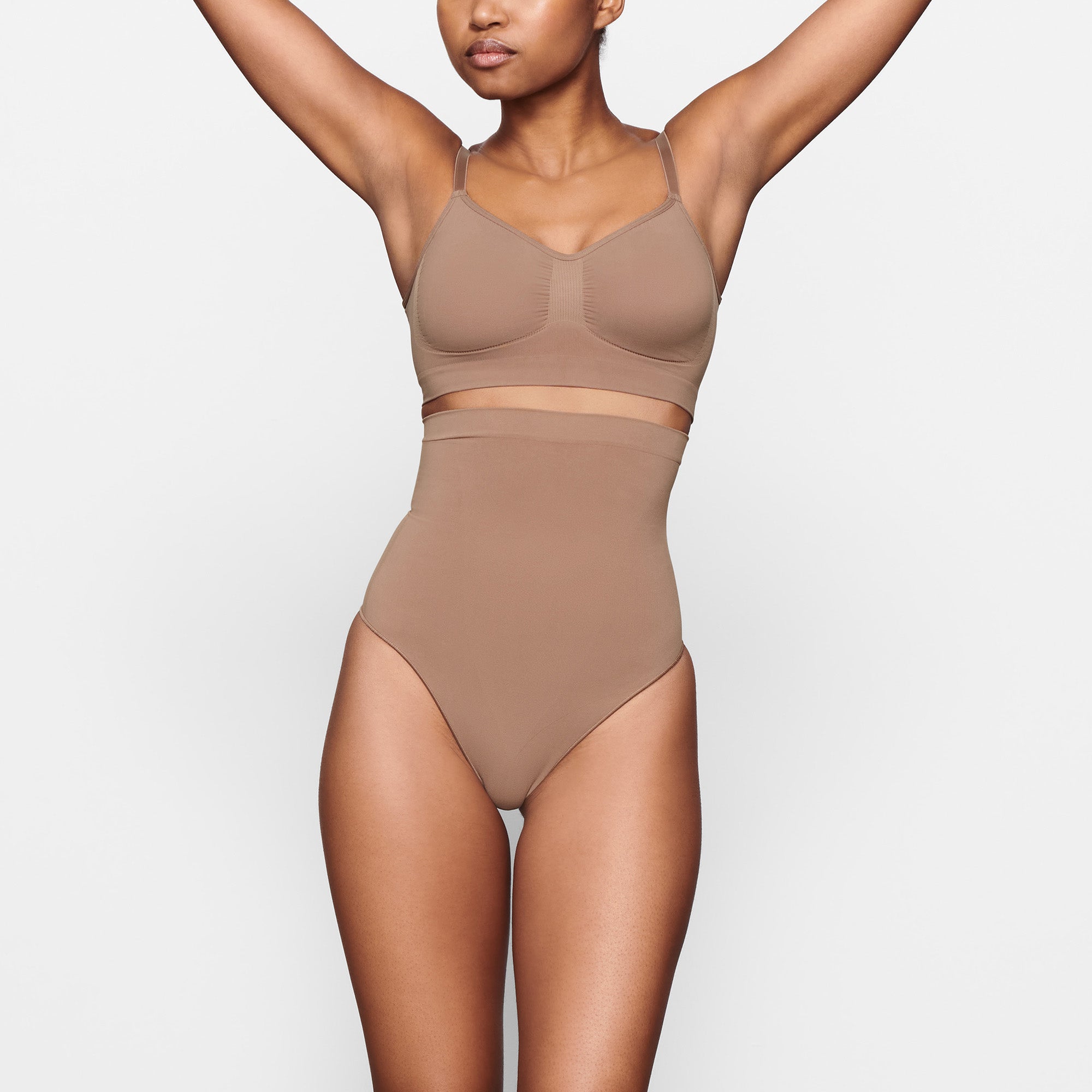 SEAMLESS SCULPT HIGH-WAISTED THONG WORN BY A MODEL IN FRONT VIEW 