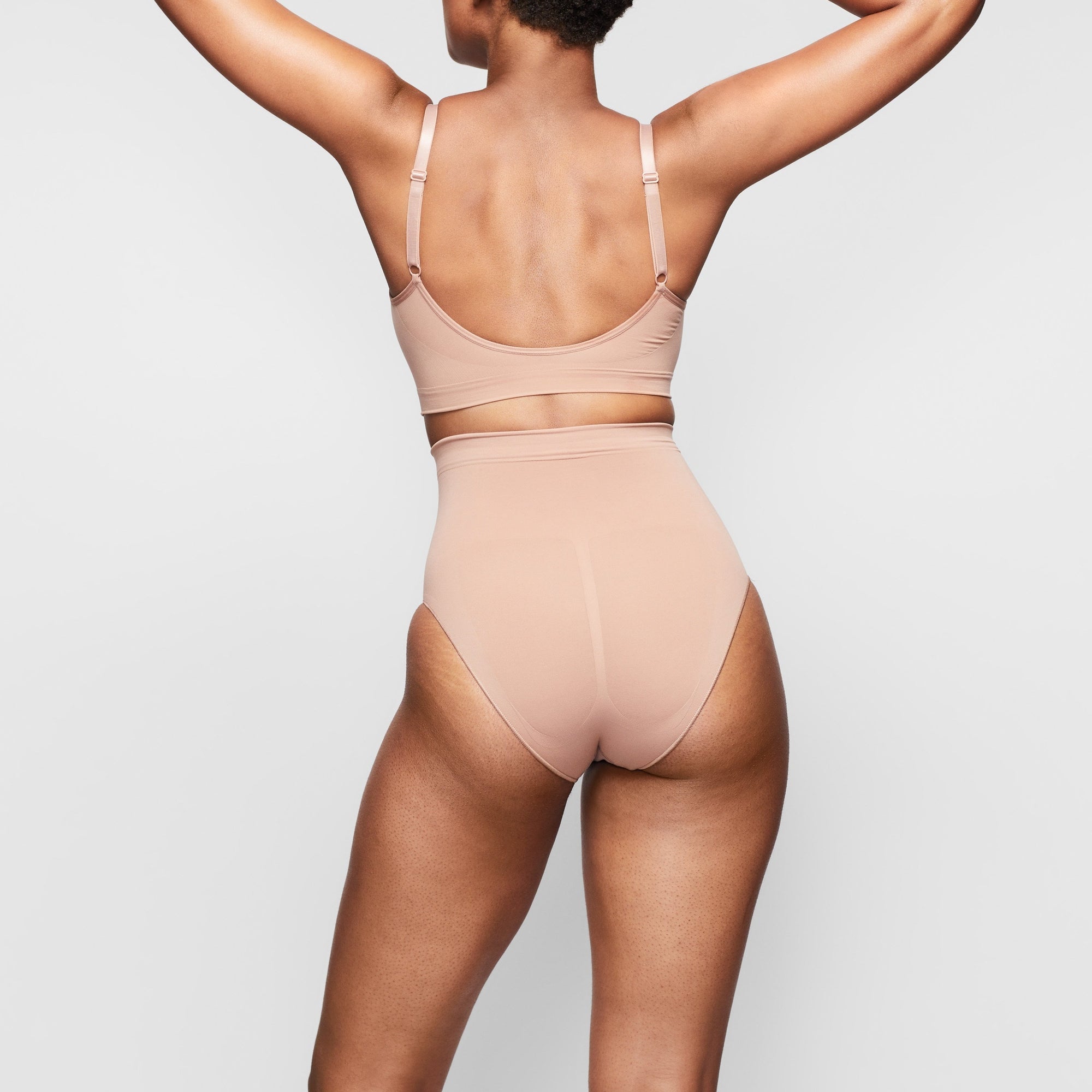 SEAMLESS SCULPT MID WAIST BRIEF ON A MODEL BACK VIEW