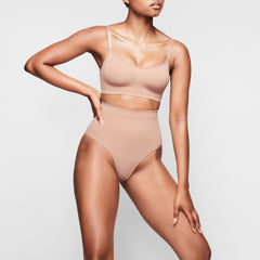 SEAMLESS SCULPT MID WAIST BRIEF WORN BY A MODEL IN FRONT VIEW, XL