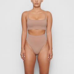 SEAMLESS SCULPT MID WAIST THONG WORN BY A MODEL IN FRONT VIEW, XL
