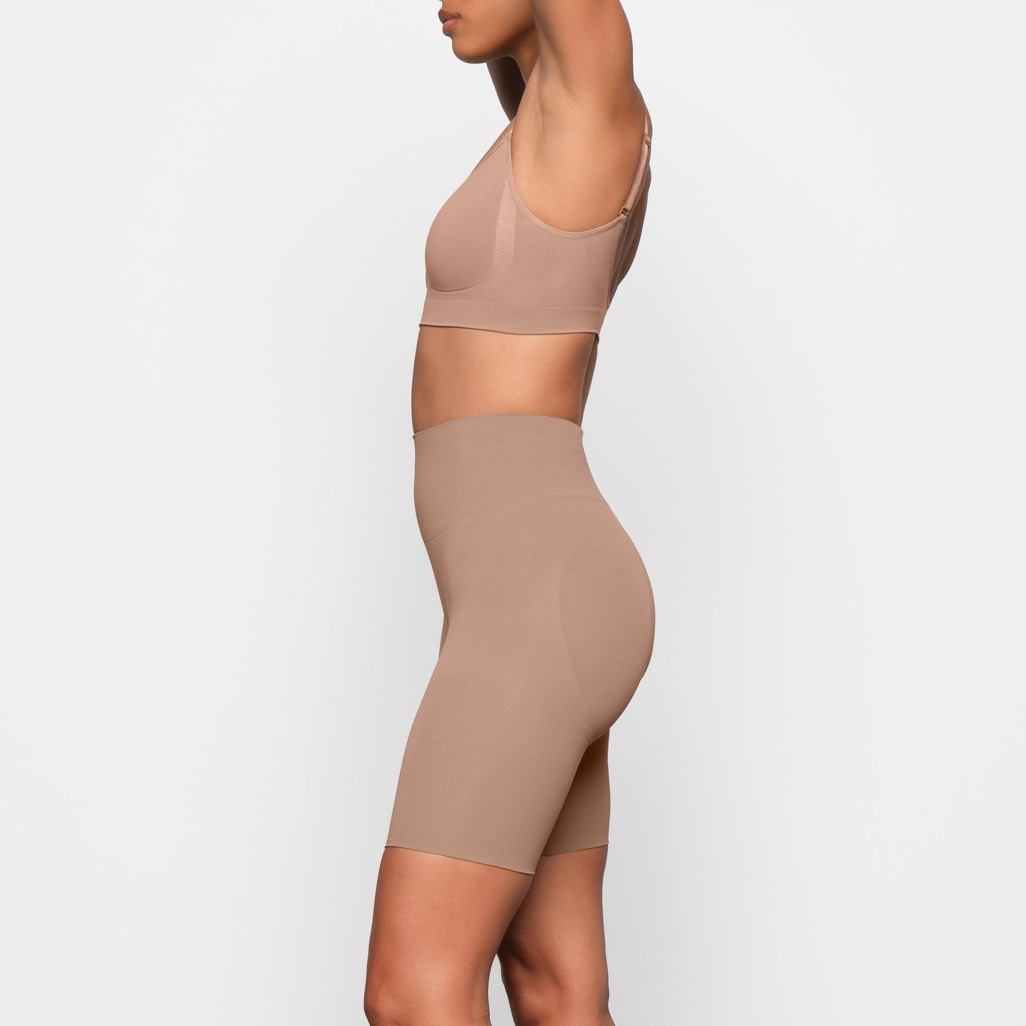 BUTT ENHANCING SHORT WORN BY A MODEL IN SIDE VIEW