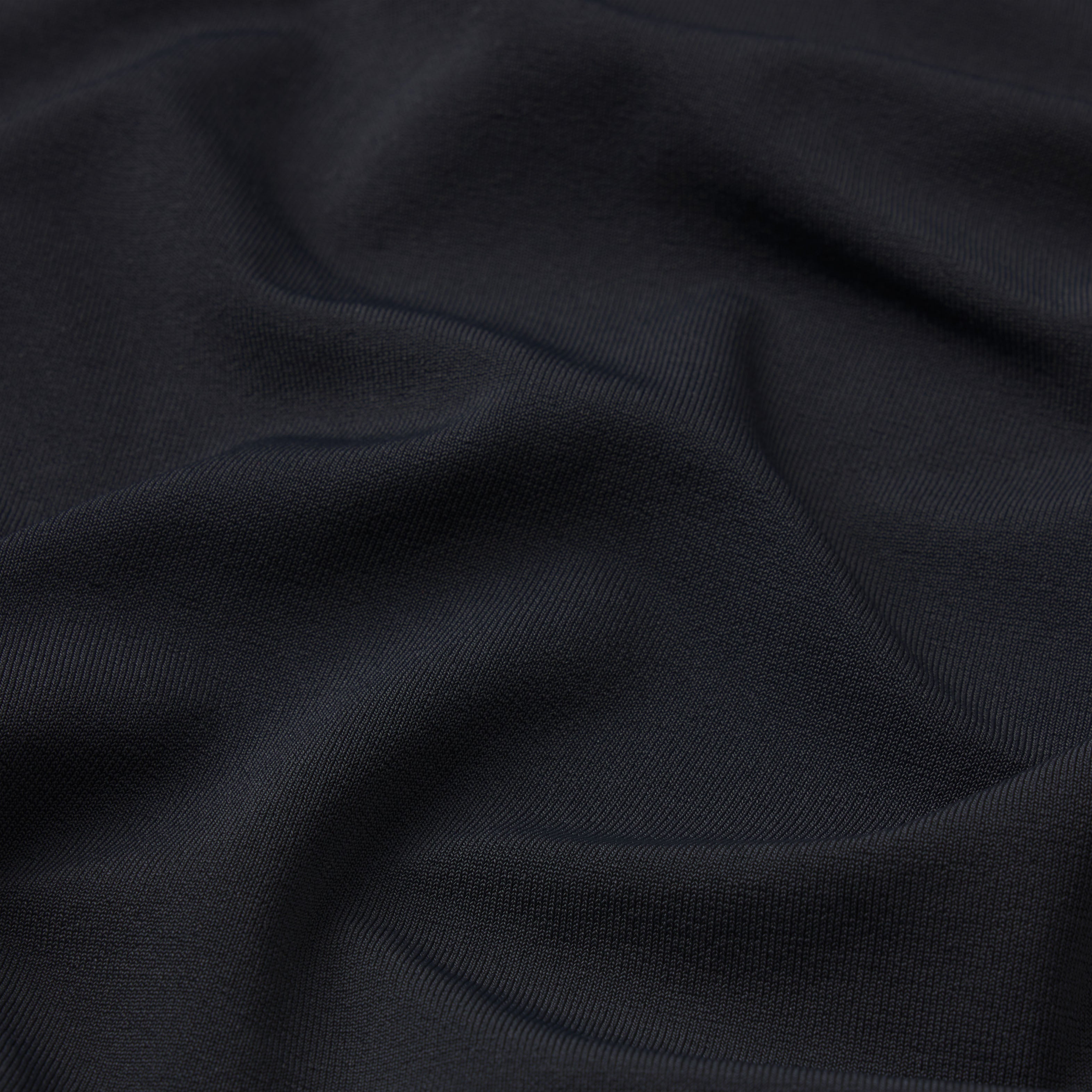 NikeSKIMS STRETCH KNIT CROPPED T-SHIRT | OBSIDIAN & LAYS FLAT ON A WHITE BACKGROUND | FLT