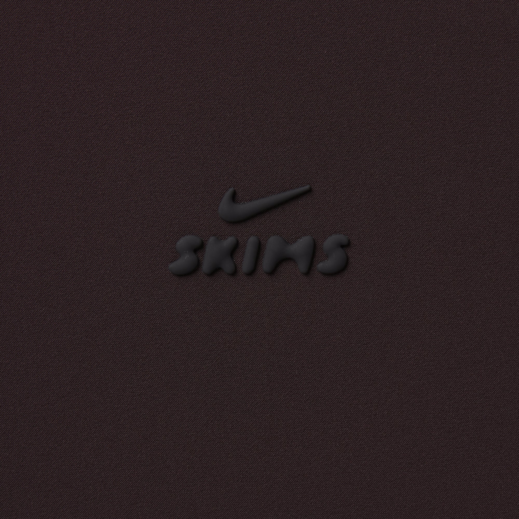 NikeSKIMS STRETCH NYLON OVERSIZED TRACK JACKET | DARK ROAST & LAYS FLAT ON A WHITE BACKGROUND | FLT