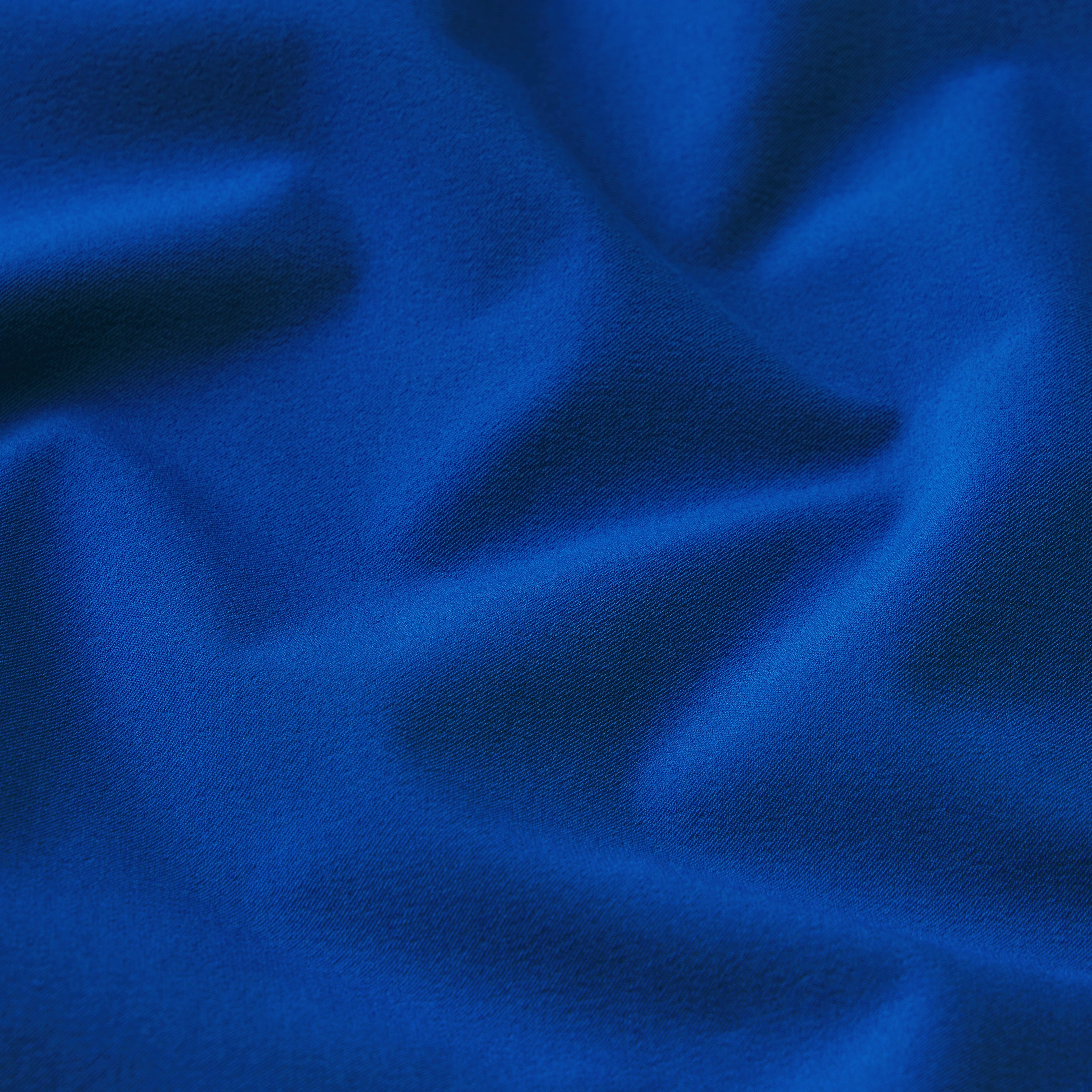 NikeSKIMS STRETCH NYLON OVERSIZED PANT | COBALT & LAYS FLAT ON A WHITE BACKGROUND | FLT