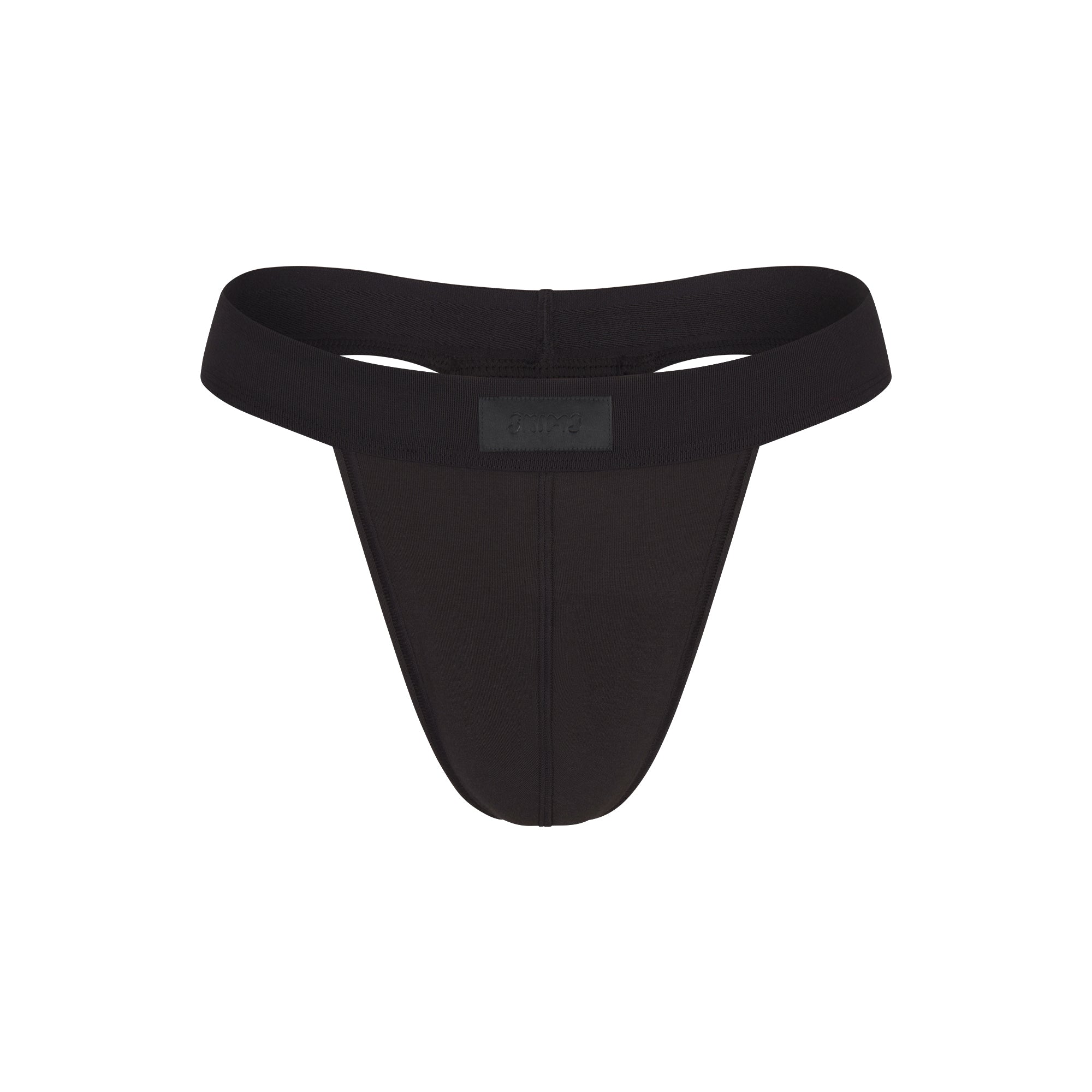 SKIMS COTTON MENS THONG | ONYX FLAT ON A WHITE BACKGROUND | FLT