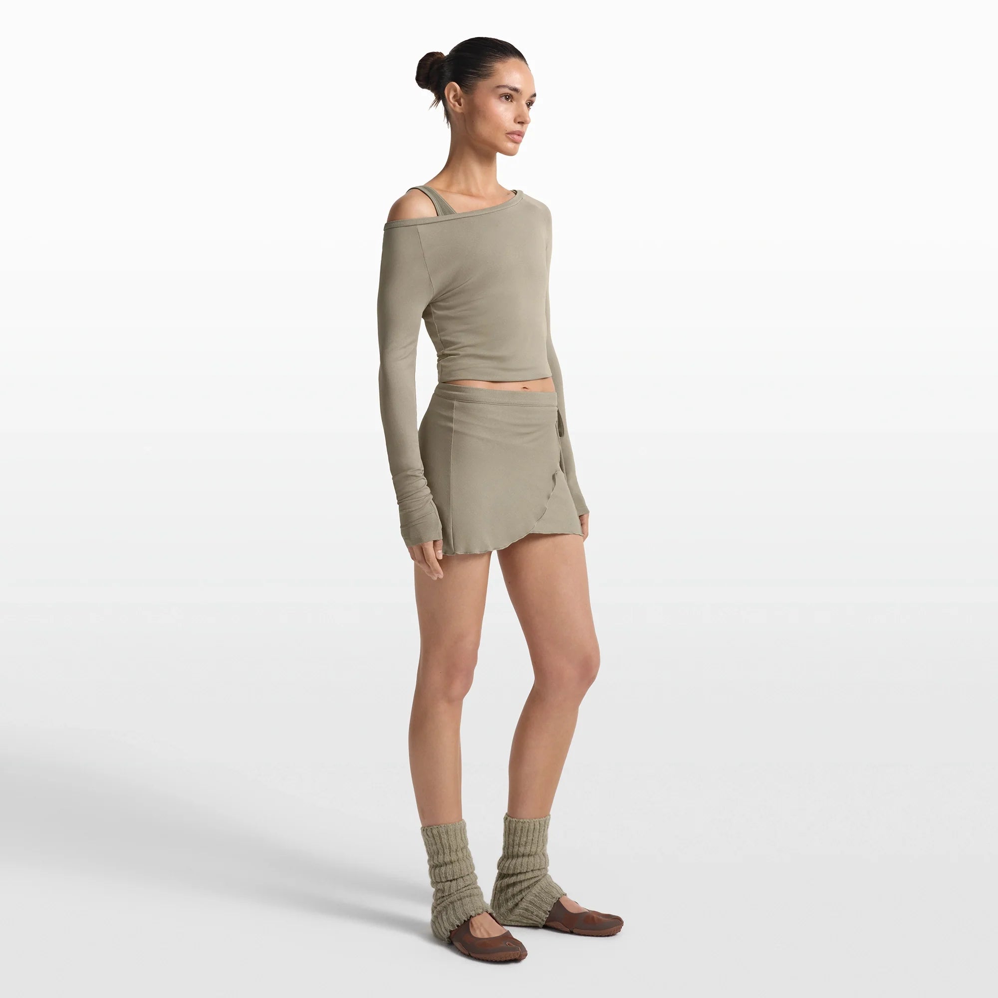 NikeSKIMS STRETCH KNIT WRAP SKIRT | DUNE ON A MODEL FRONT VIEW @ | FOCUS: 0.0, 1.0, 0.9