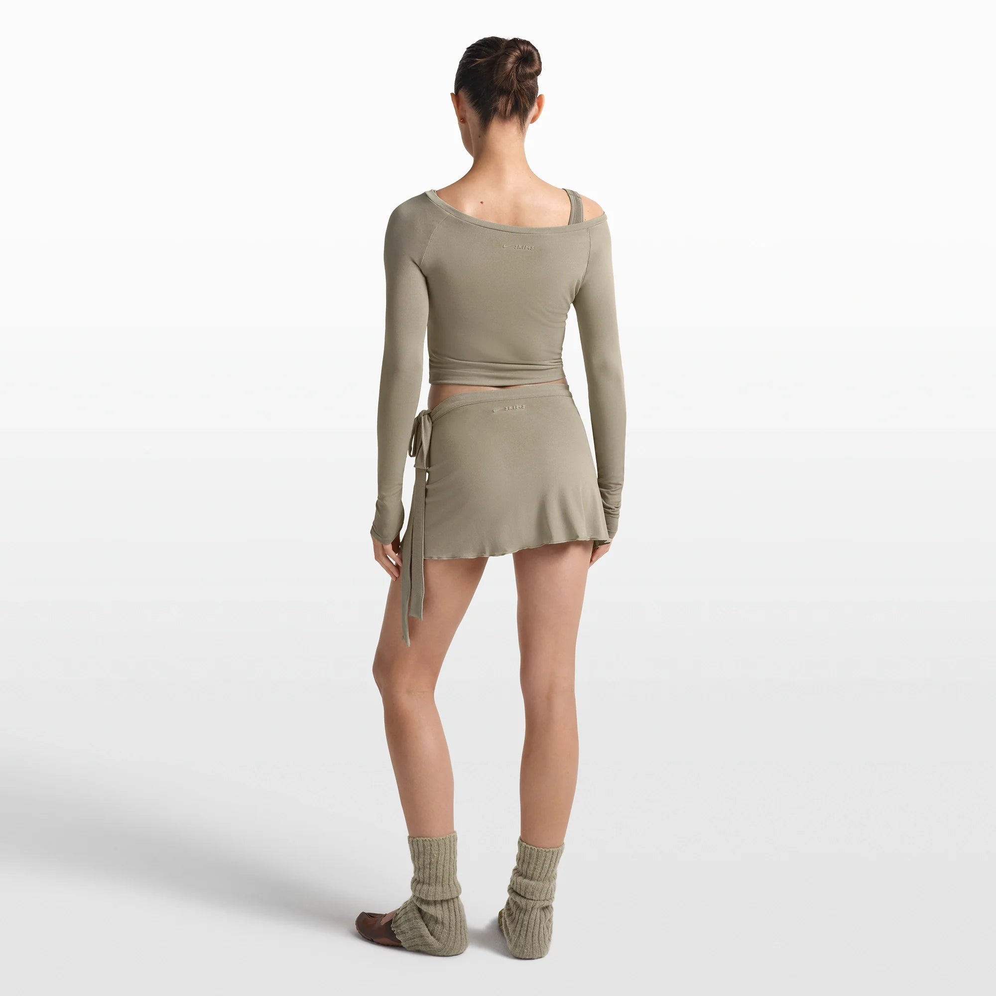 NikeSKIMS STRETCH KNIT WRAP SKIRT | DUNE ON A MODEL FRONT VIEW @ | FOCUS: 0.0, 1.0, 0.9