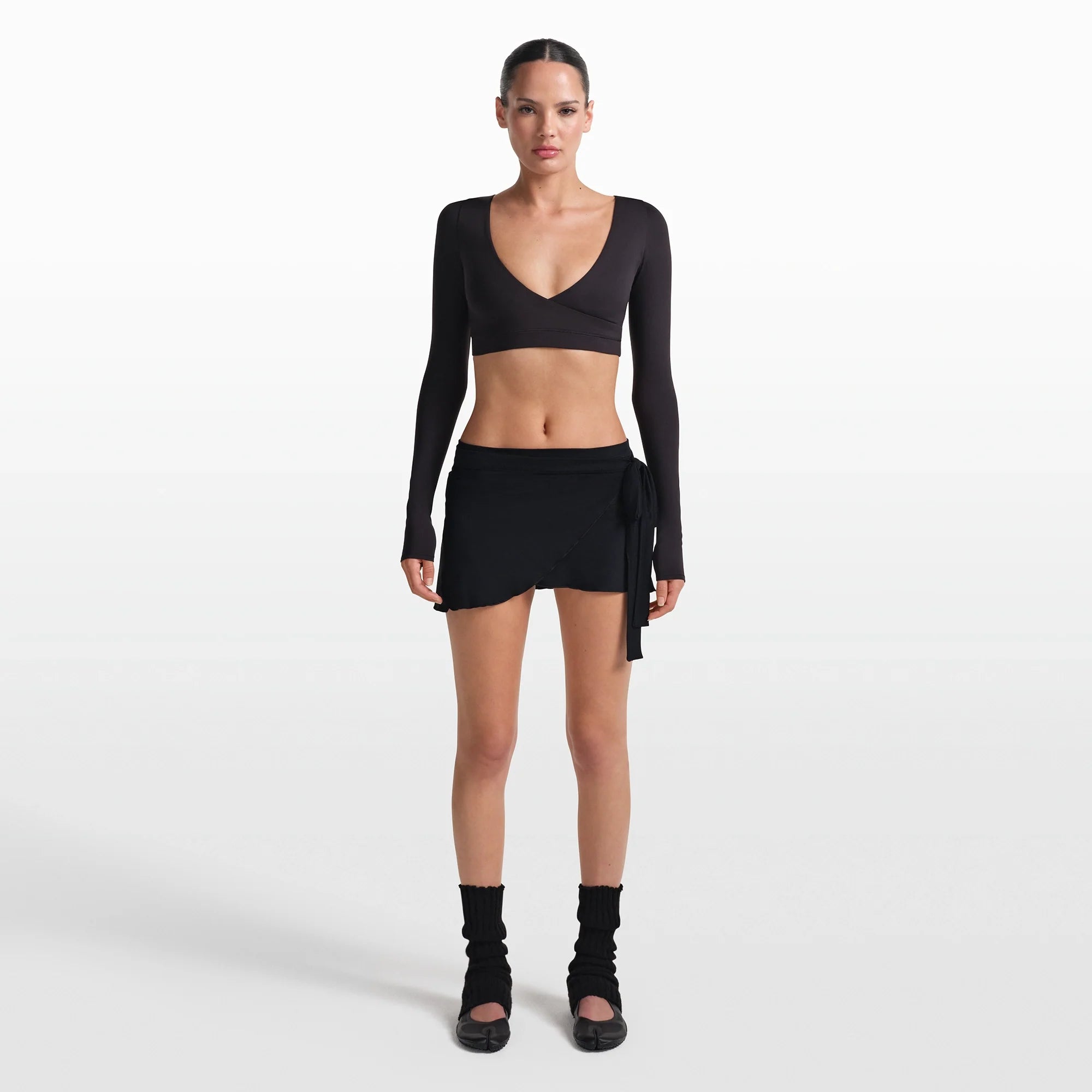 NikeSKIMS STRETCH KNIT WRAP SKIRT | OBSIDIAN ON A MODEL FRONT VIEW @ | FOCUS: 0.0, 1.0, 0.9
