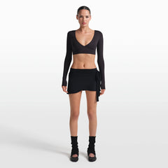 NikeSKIMS STRETCH KNIT WRAP SKIRT | OBSIDIAN ON A MODEL FRONT VIEW @ | FOCUS: 0.0, 1.0, 0.9