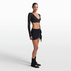 NikeSKIMS STRETCH KNIT WRAP SKIRT | OBSIDIAN ON A MODEL FRONT VIEW @ | FOCUS: 0.0, 1.0, 0.9
