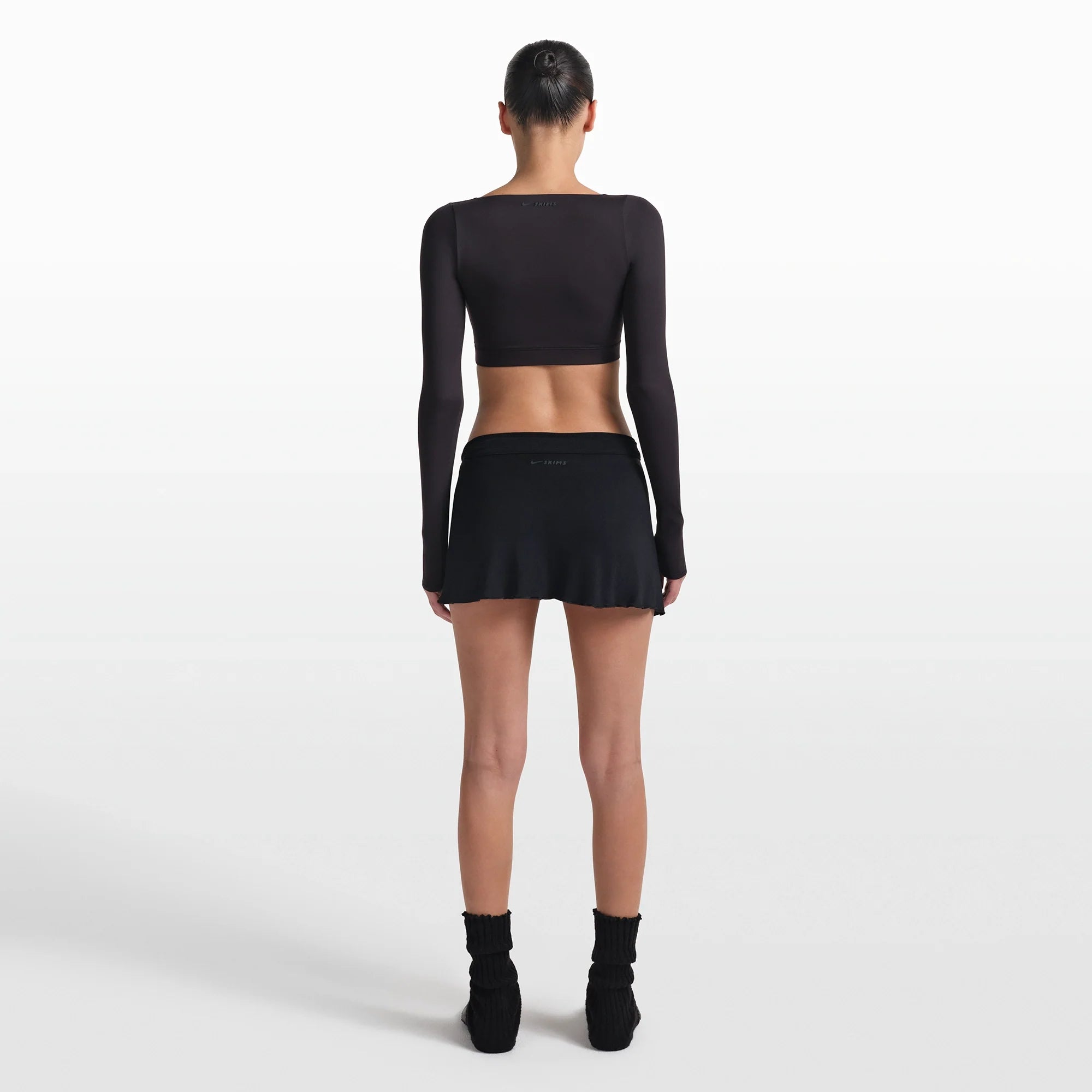 NikeSKIMS STRETCH KNIT WRAP SKIRT | OBSIDIAN ON A MODEL FRONT VIEW @ | FOCUS: 0.0, 1.0, 0.9