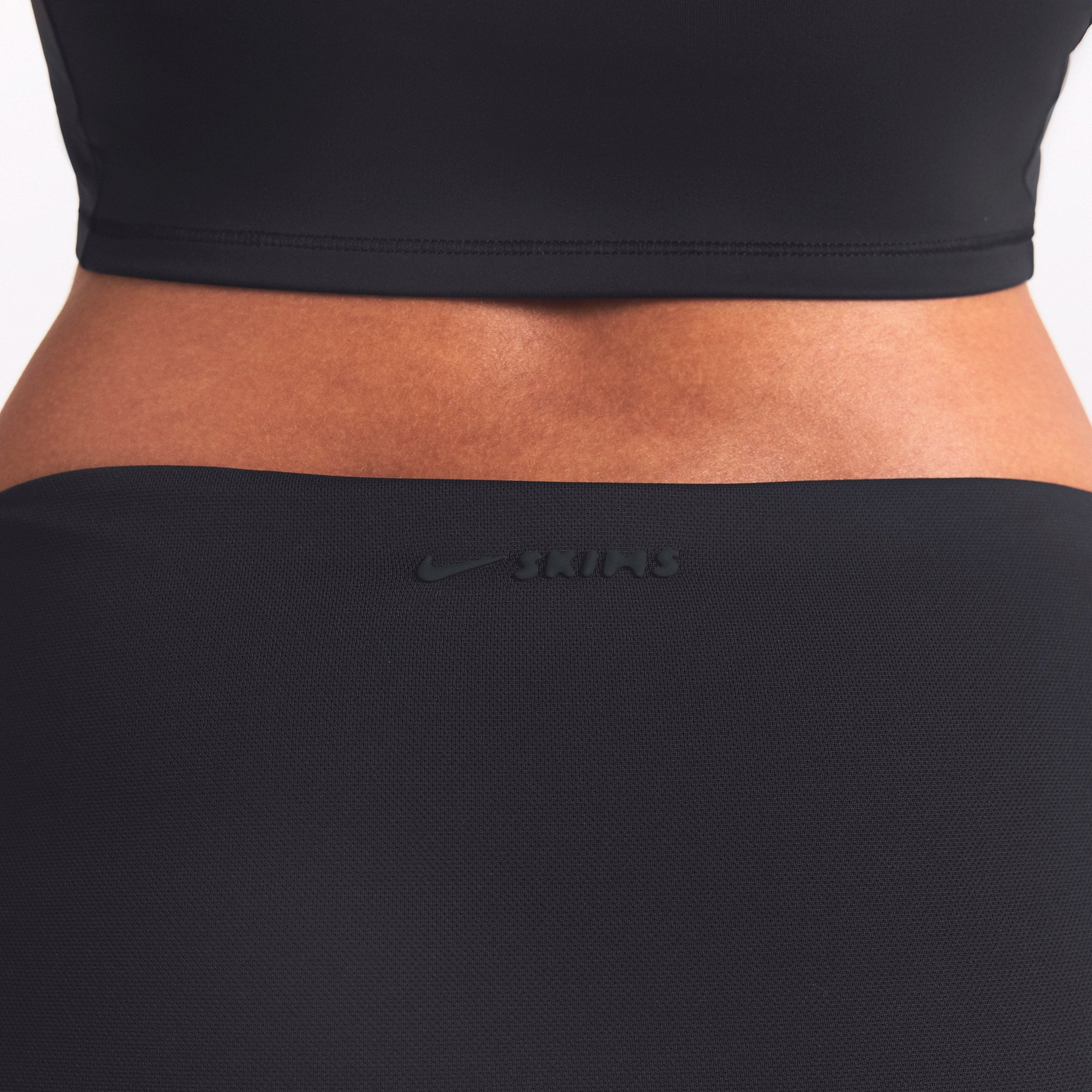 NikeSKIMS AIRY FOLDOVER SKORT | OBSIDIAN ON A MODEL SIDE VIEW @ | FOCUS: 0.0, 1.0, 0.9