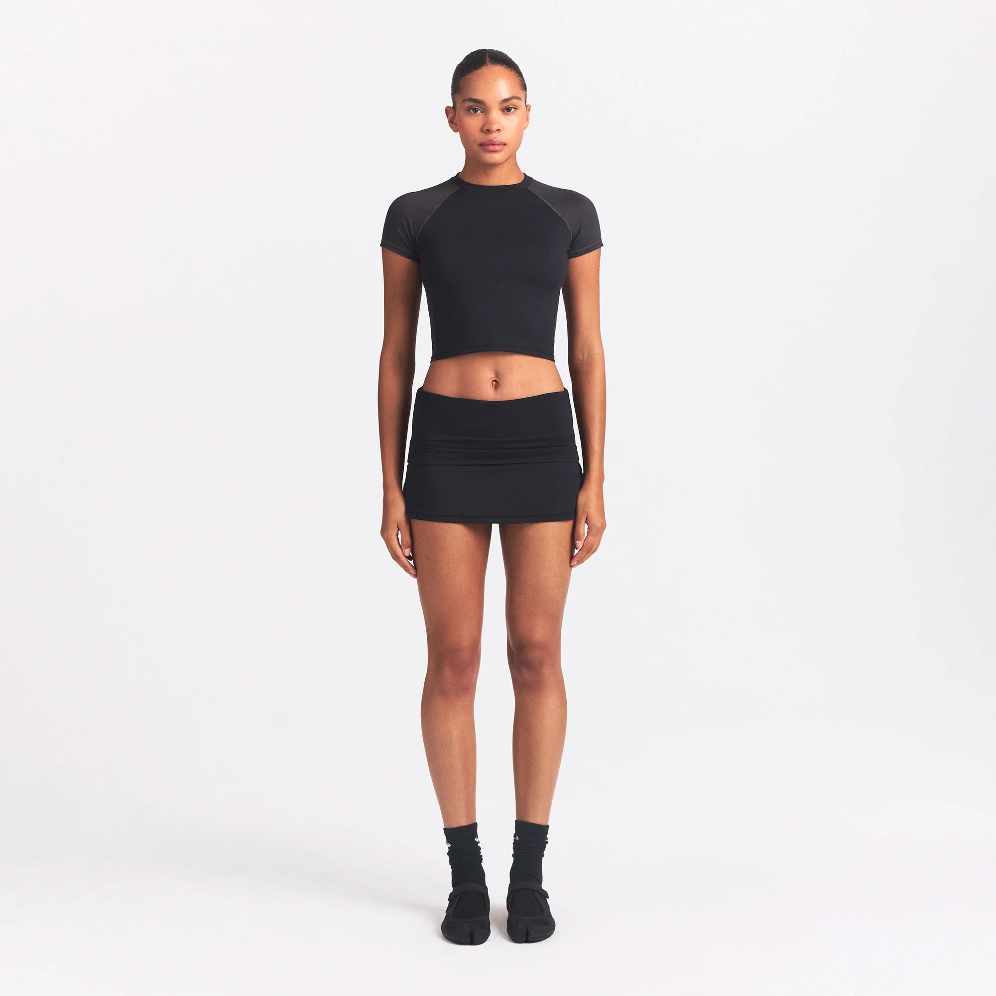 NikeSKIMS AIRY FOLDOVER SKORT | OBSIDIAN ON A MODEL FRONT VIEW @ | FOCUS: 0.0, 1.0, 0.9