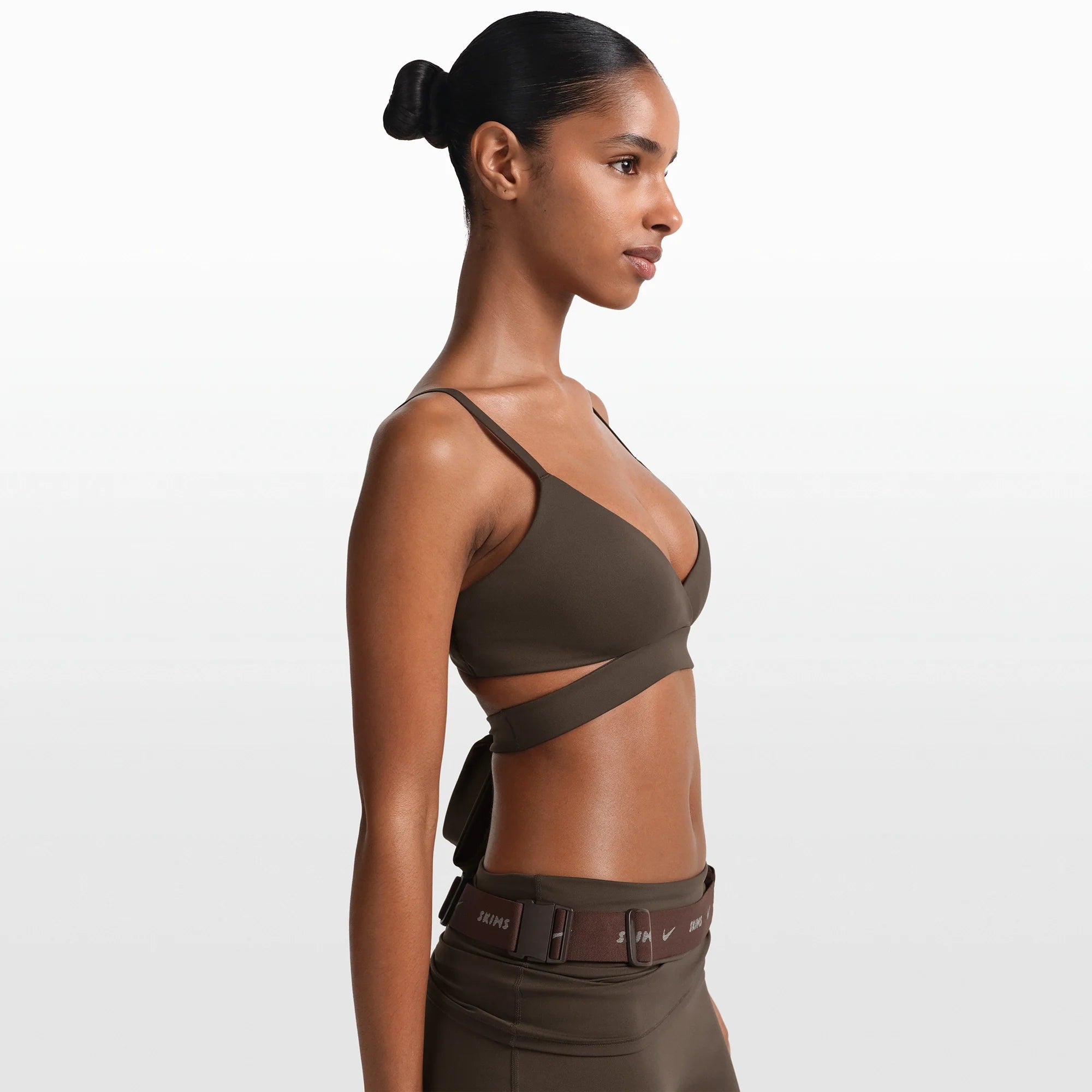 NikeSKIMS MATTE WRAP FRONT BRA | DARK SEPIA ON A MODEL FRONT VIEW @ | FOCUS: 0.0, 1.0, 0.9