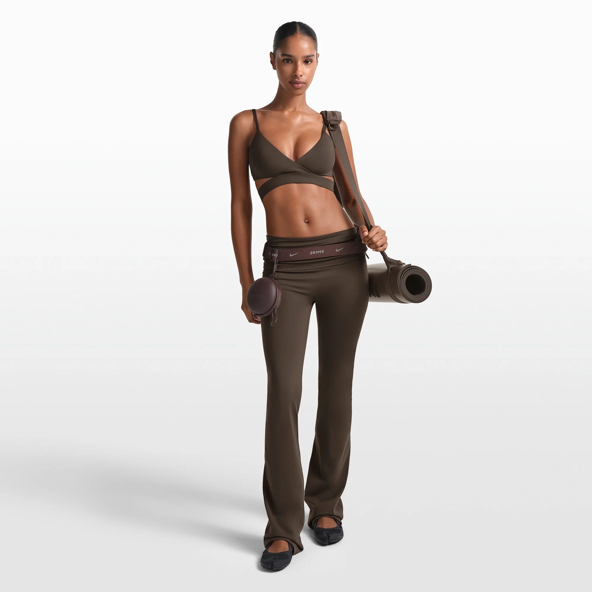 NikeSKIMS MATTE WRAP FRONT BRA | DARK SEPIA ON A MODEL FRONT VIEW @ | FOCUS: 0.0, 1.0, 0.9