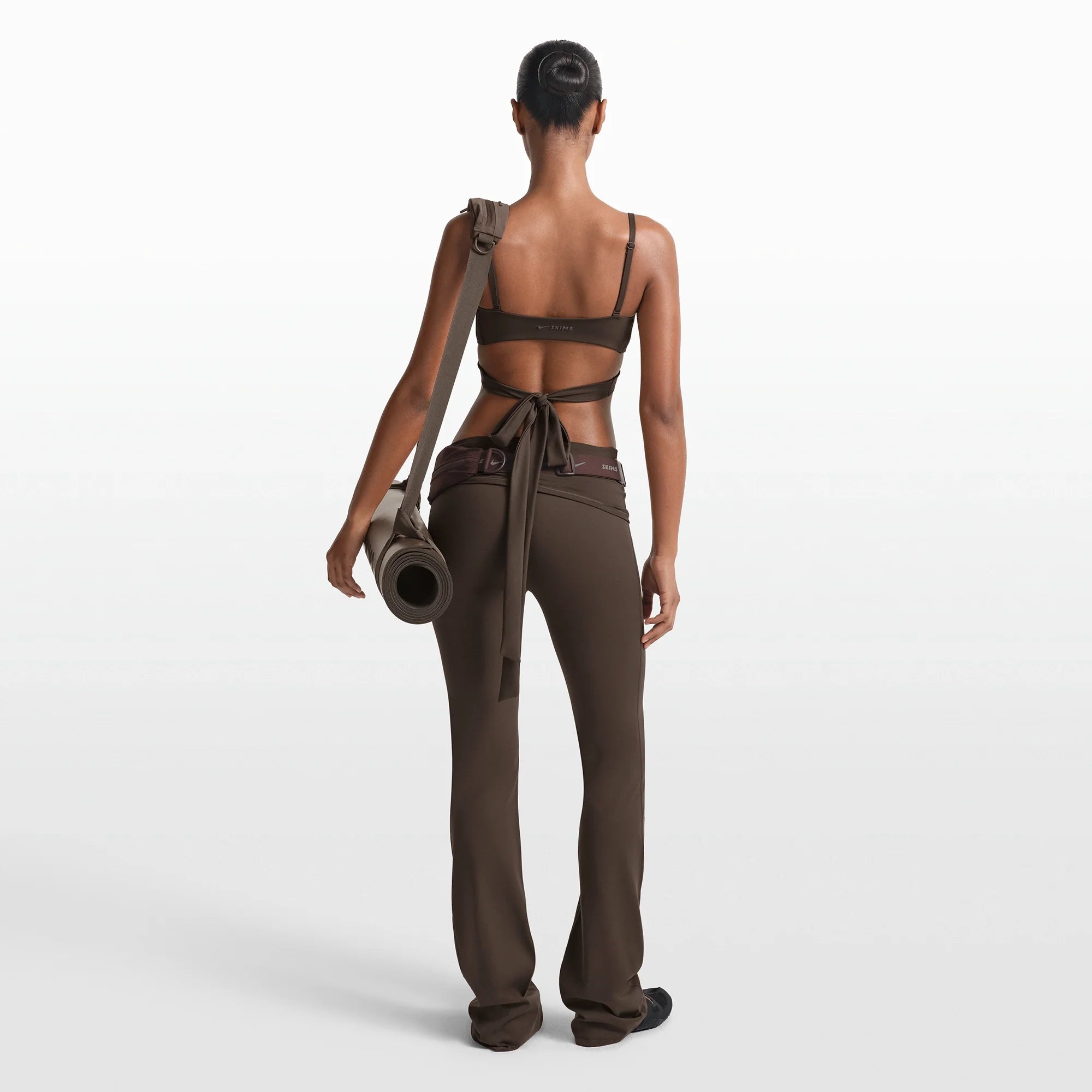 NikeSKIMS MATTE WRAP FRONT BRA | DARK SEPIA ON A MODEL FRONT VIEW @ | FOCUS: 0.0, 1.0, 0.9