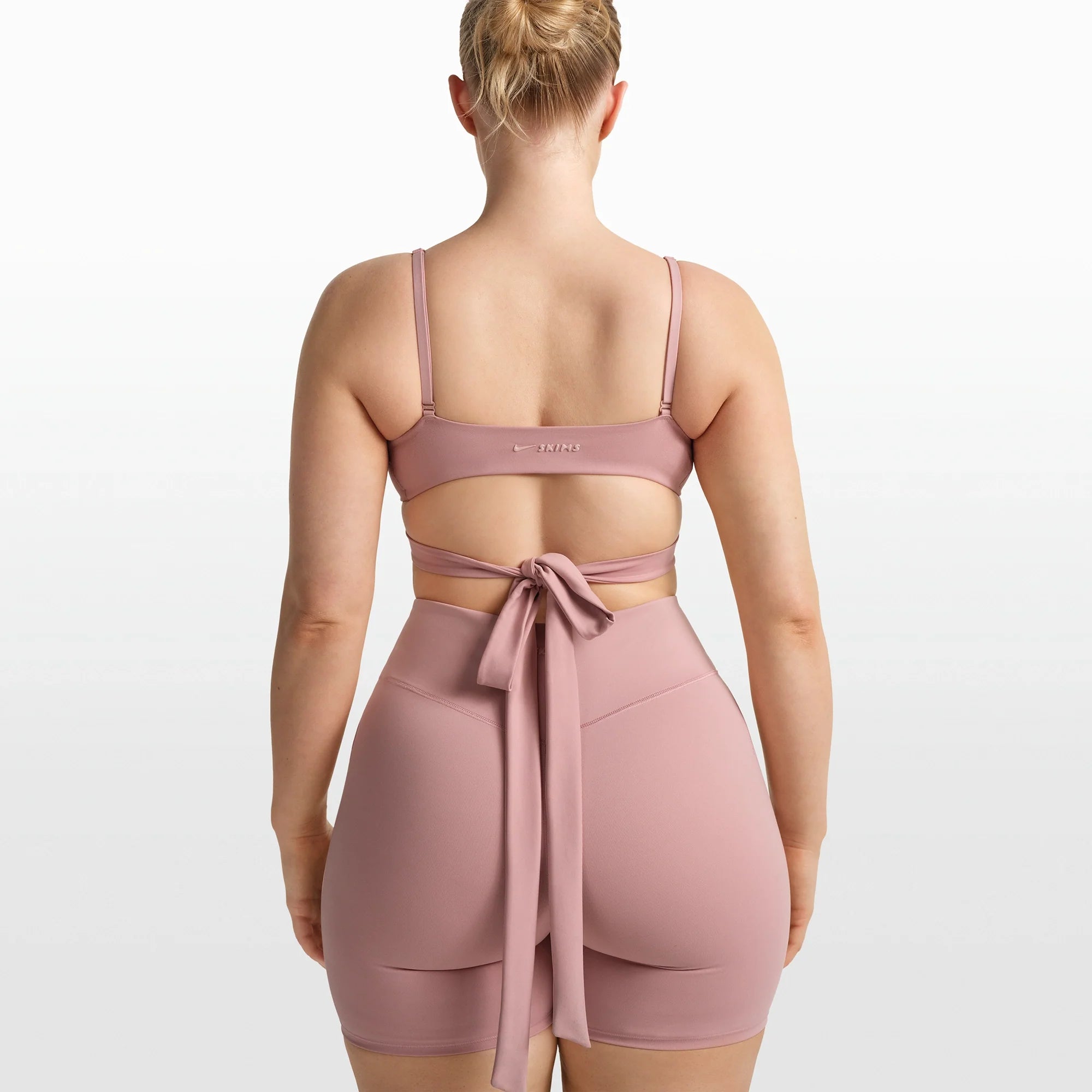 NikeSKIMS MATTE WRAP FRONT BRA | HIMALAYAN ON A MODEL FRONT VIEW @ | FOCUS: 0.0, 1.0, 0.9
