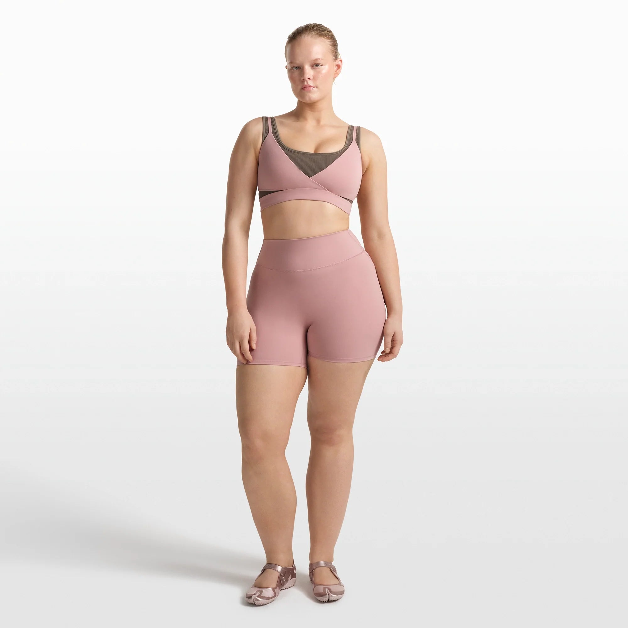 NikeSKIMS MATTE WRAP FRONT BRA | HIMALAYAN ON A MODEL FRONT VIEW @ | FOCUS: 0.0, 1.0, 0.9