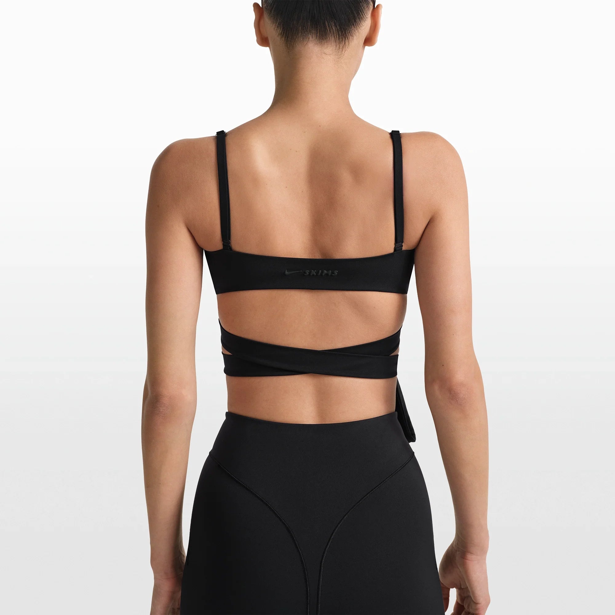 NikeSKIMS MATTE WRAP FRONT BRA | OBSIDIAN ON A MODEL FRONT VIEW @ | FOCUS: 0.0, 1.0, 0.9