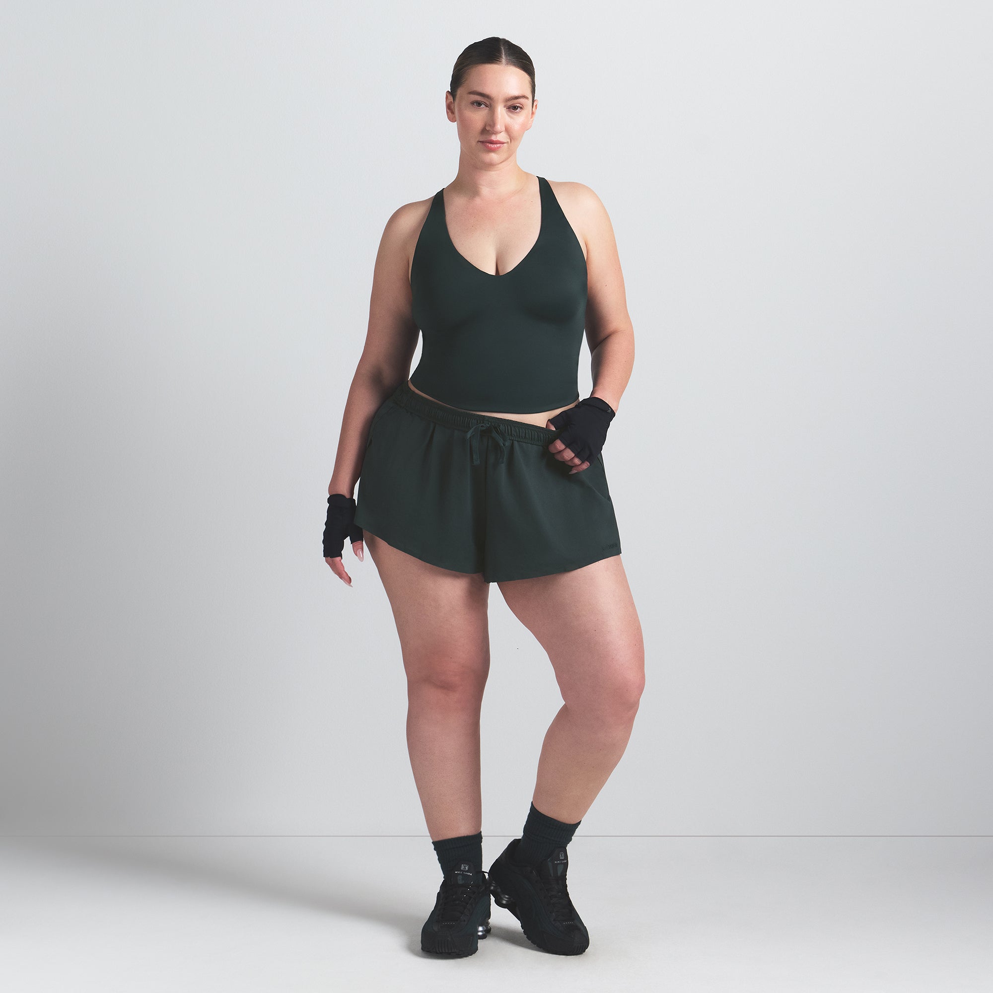NikeSKIMS SHINE V-NECK TANK | DARK TEAL ON A MODEL FRONT VIEW @ | FOCUS: 0.0, 1.0, 0.9