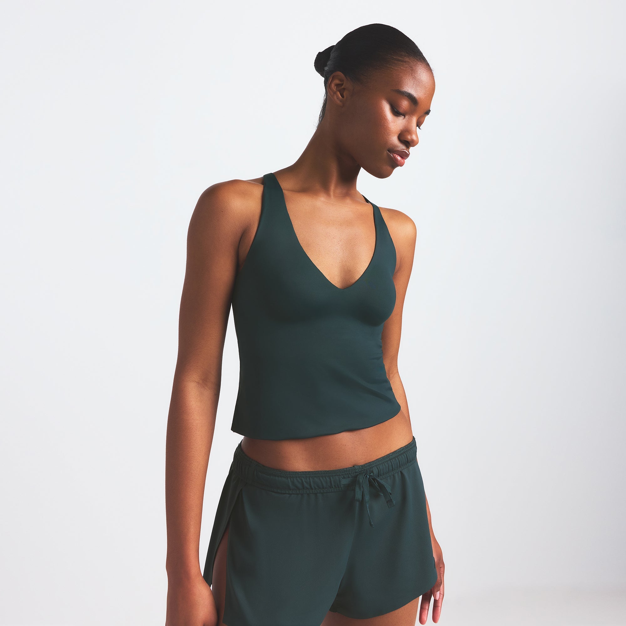 NikeSKIMS SHINE V-NECK TANK | DARK TEAL ON A MODEL SIDE VIEW @ | FOCUS: 0.0, 1.0, 0.9