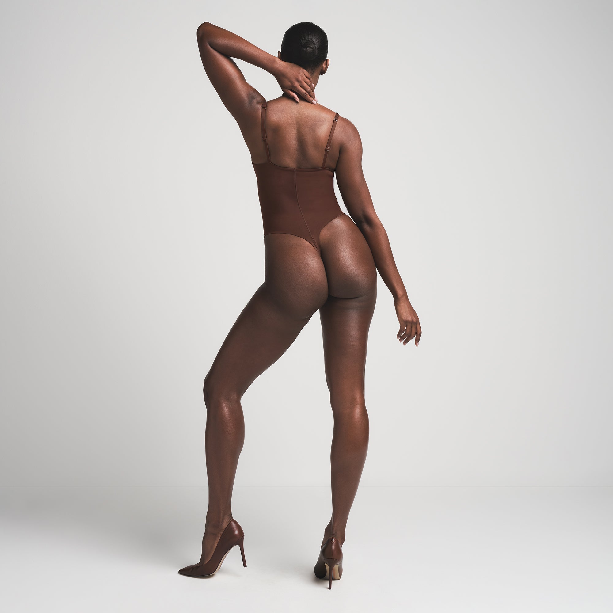 SKIMS ULTIMATE BODY PUSH-UP THONG BODYSUIT | COCOA  ON A MODEL BACK VIEW