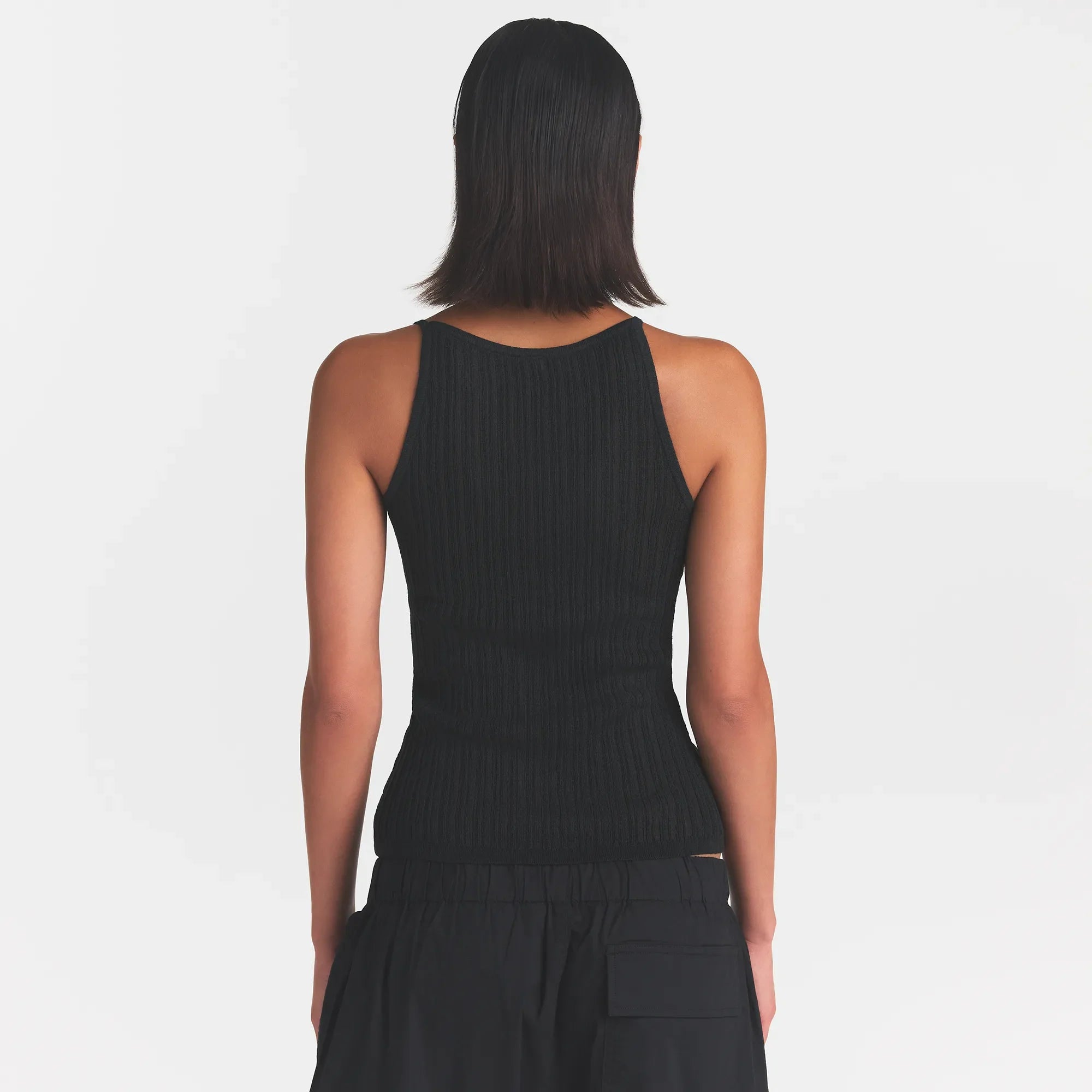 SHEER KNIT PLUNGE TANK | ONYX ON A MODEL BACK VIEW @ | FOCUS: 0.0, 1.0, 0.9