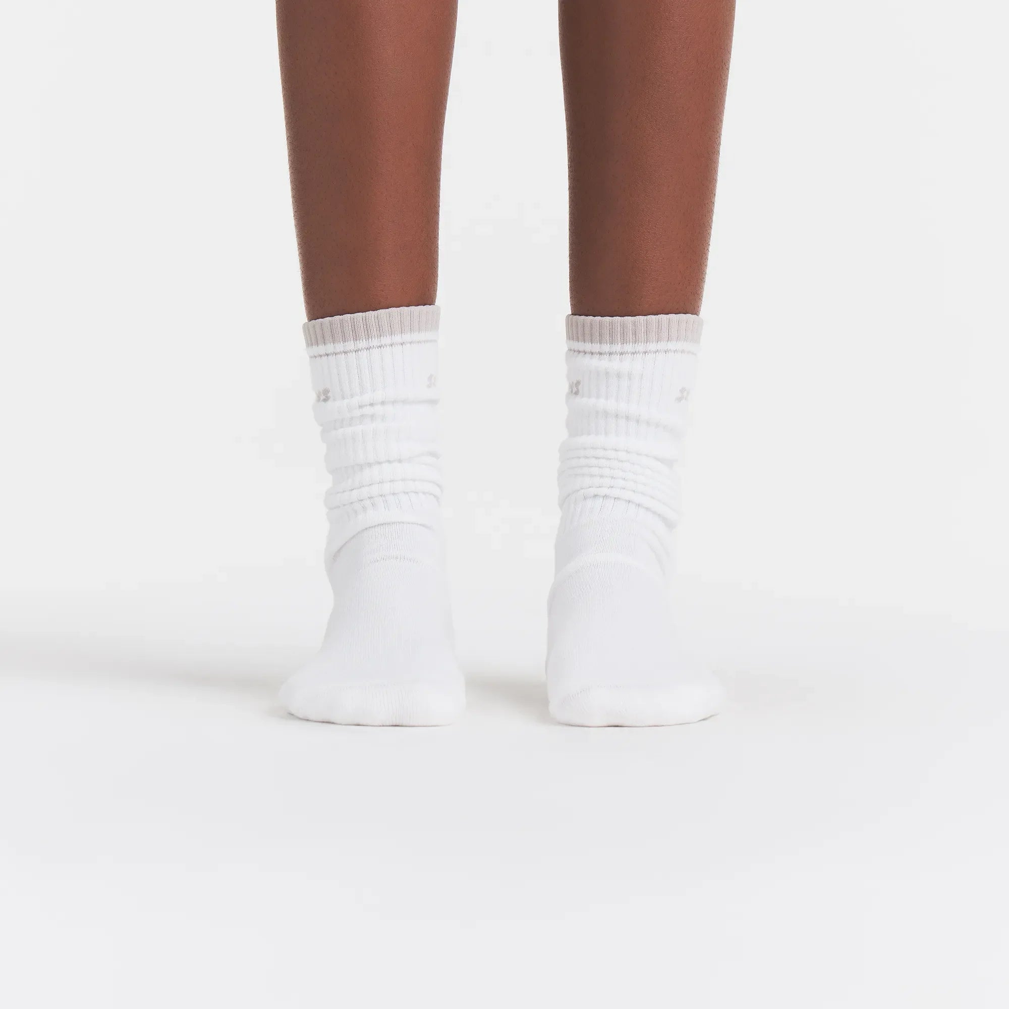 RIBBED CREW LOGO SOCK | SNOW AND STONE ON A MODEL | FOCUS: 0.0, 1.0, 0.9