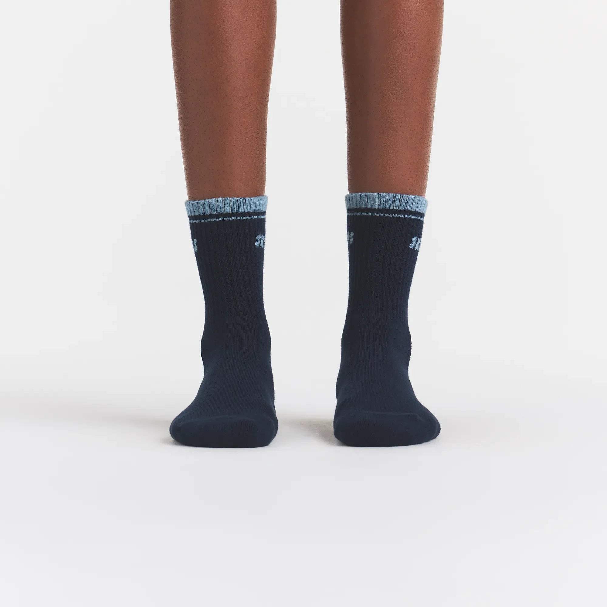 RIBBED QUARTER CREW LOGO SOCK | NAVY AND KYANITE ON A MODEL | FOCUS: 0.0, 1.0, 0.9