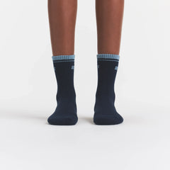 RIBBED QUARTER CREW LOGO SOCK | NAVY AND KYANITE ON A MODEL | FOCUS: 0.0, 1.0, 0.9
