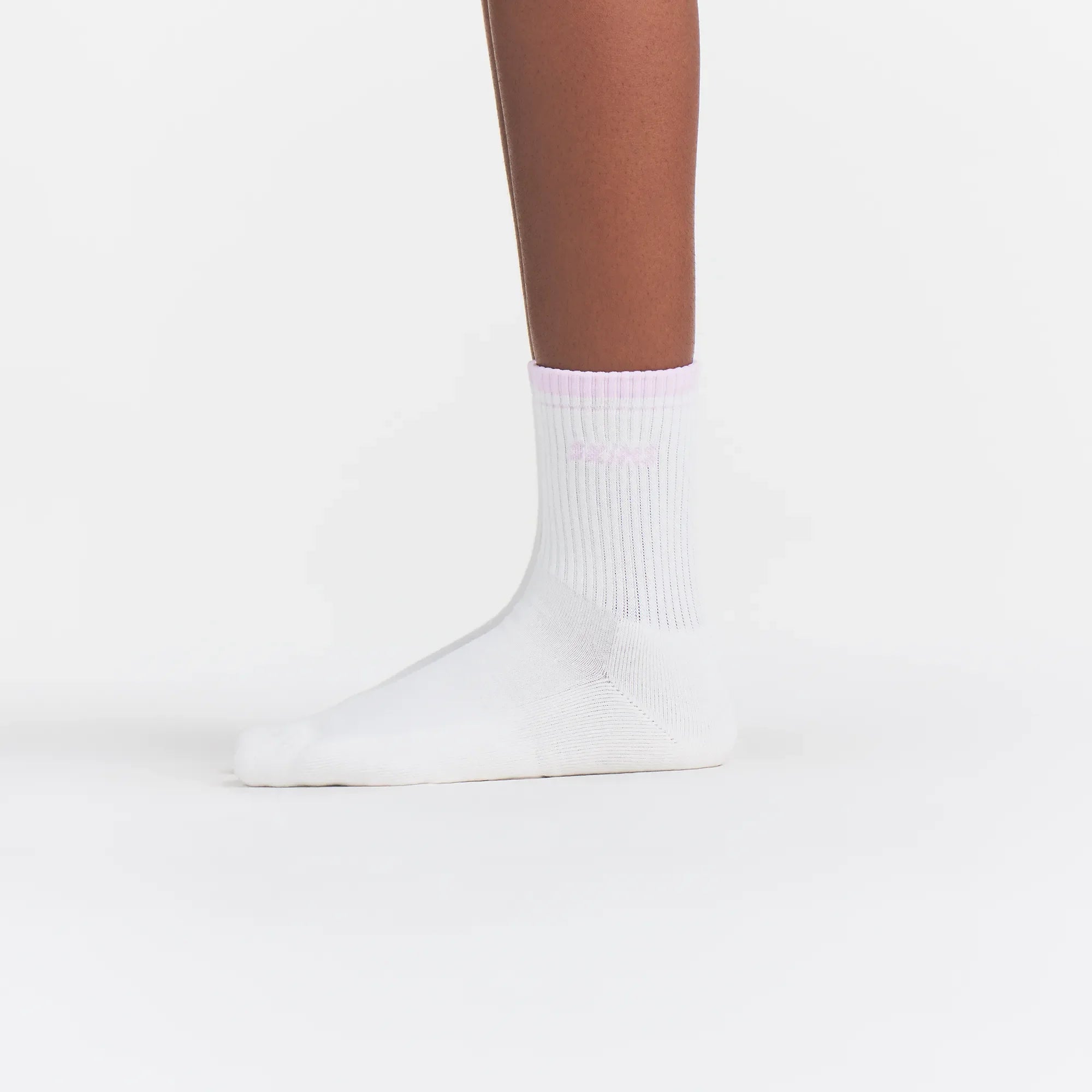 RIBBED QUARTER CREW LOGO SOCK | SNOW AND CHERRY BLOSSOM ON A MODEL | FOCUS: 0.0, 1.0, 0.9