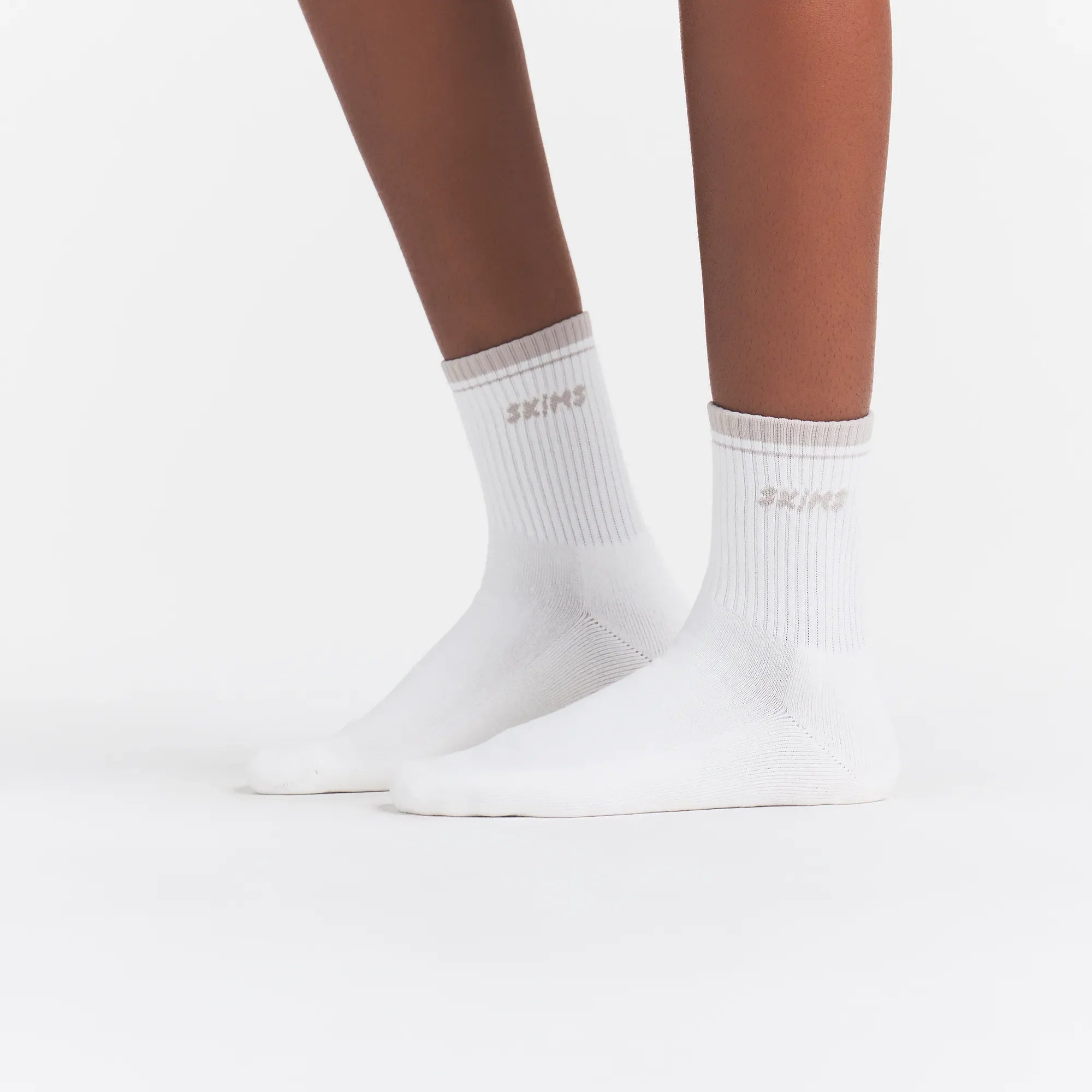 RIBBED QUARTER CREW LOGO SOCK | SNOW AND STONE ON A MODEL | FOCUS: 0.0, 1.0, 0.9