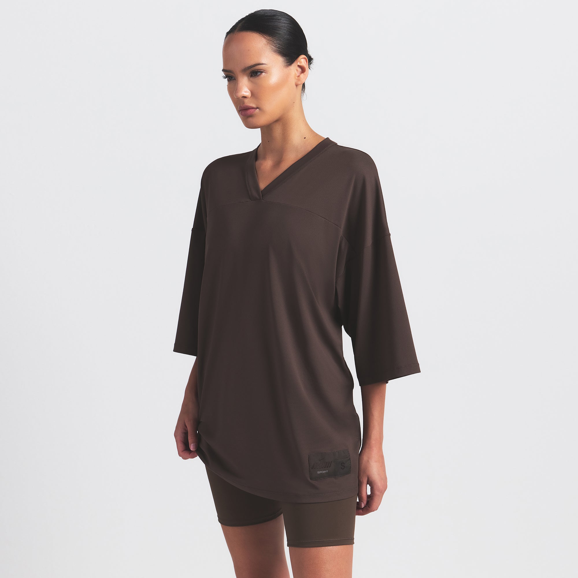 NikeSKIMS AIRY V-NECK OVERSIZED TOP | DARK SEPIA ON A MODEL SIDE VIEW @ | FOCUS: 0.9, 0.1, 0.7