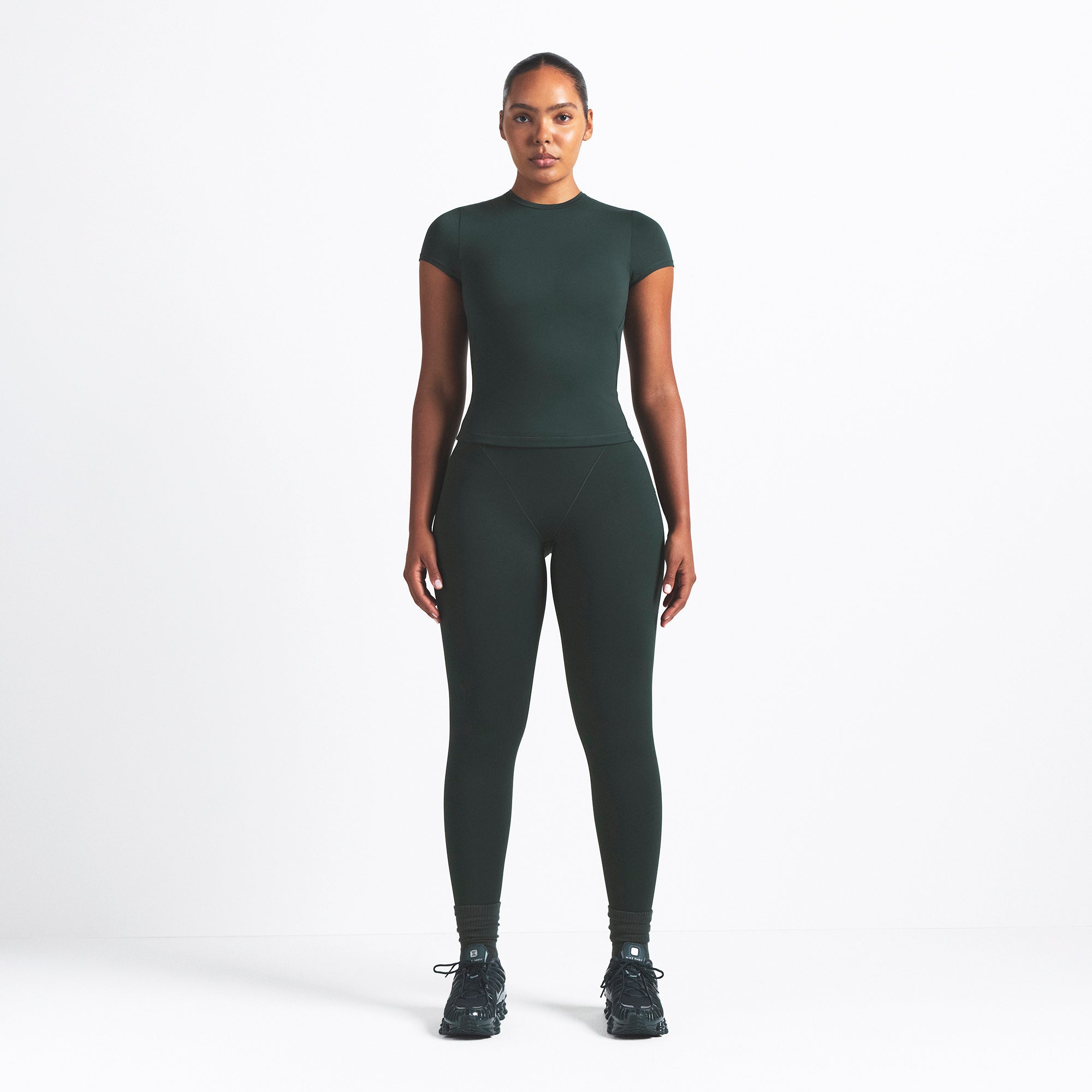 NikeSKIMS MATTE PADDED BABY TEE | DARK TEAL ON A MODEL FRONT VIEW @ | FOCUS: 0.0, 1.0, 0.9