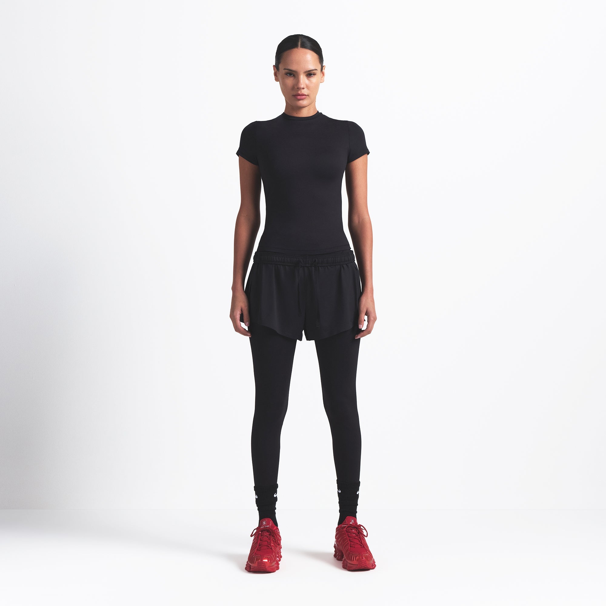 NikeSKIMS MATTE PADDED BABY TEE | OBSIDIAN ON A MODEL FRONT VIEW @ | FOCUS: 0.0, 1.0, 0.9