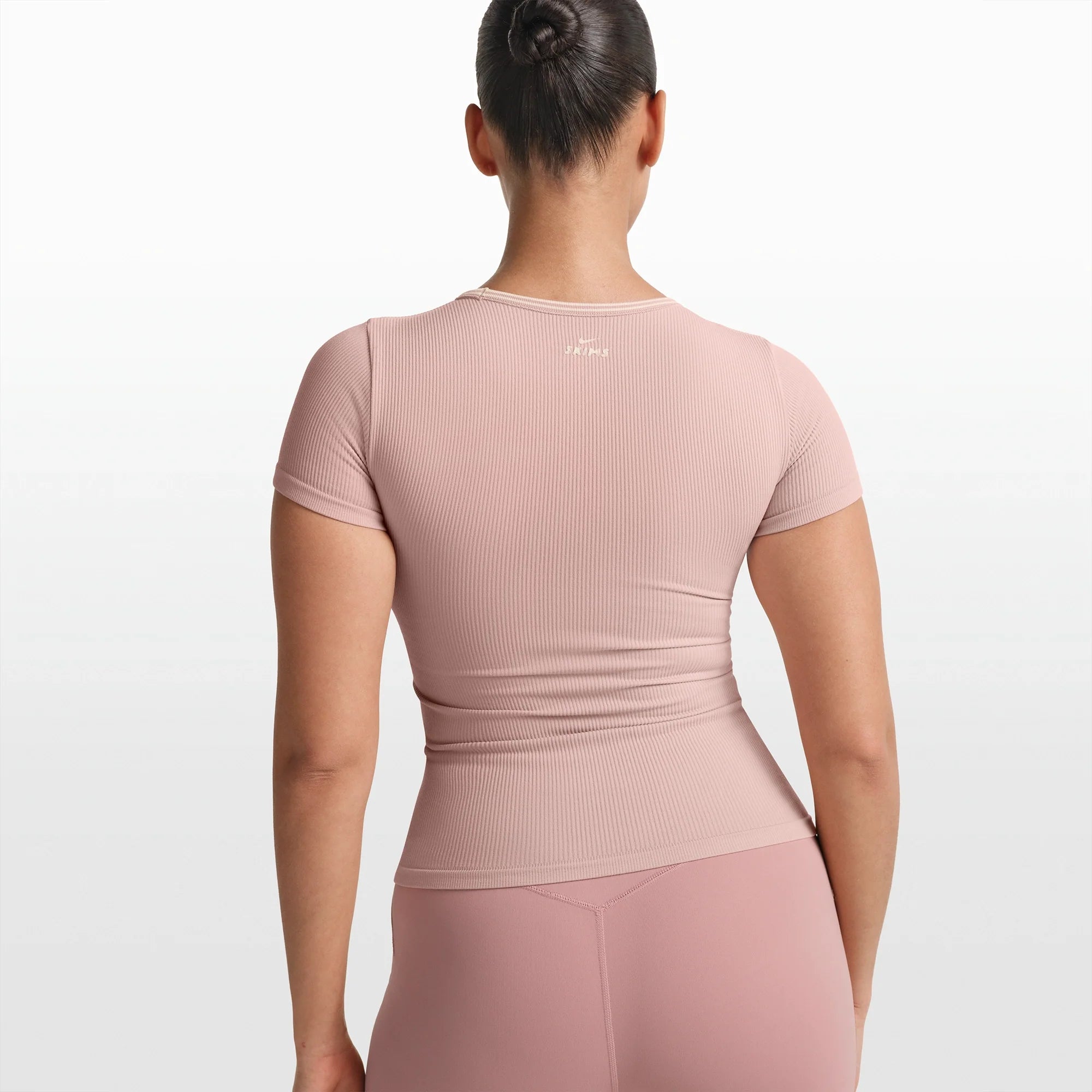 NikeSKIMS RIBBED SEAMLESS BABY TEE | HIMALAYAN/ECRU ON A MODEL FRONT VIEW @ | FOCUS: 0.0, 1.0, 0.9