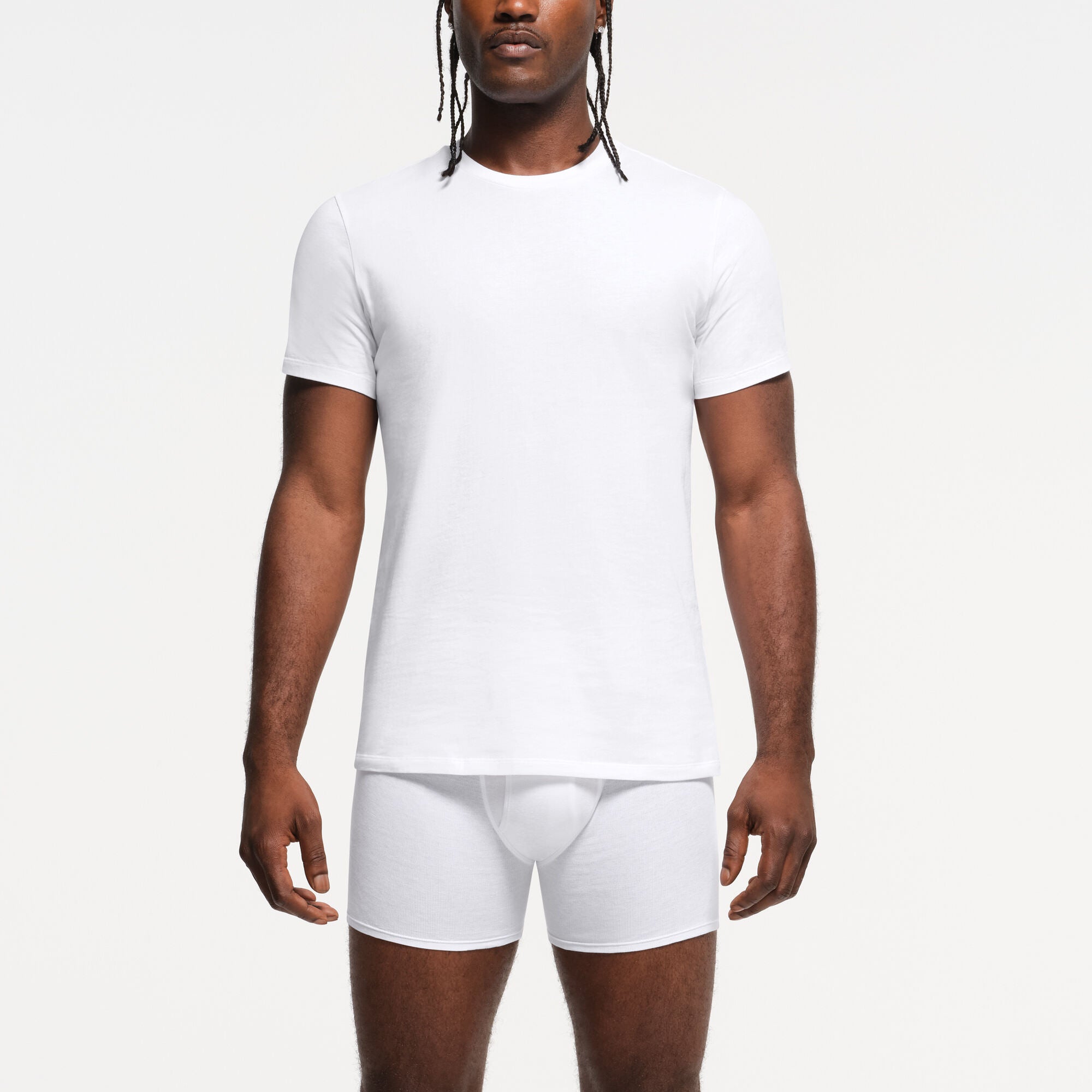 SKIMS BASICS MENS LIGHTWEIGHT T-SHIRT 3-PACK | CHALK (MENS PANTS) FLAT ON A WHITE BACKGROUND | FLT