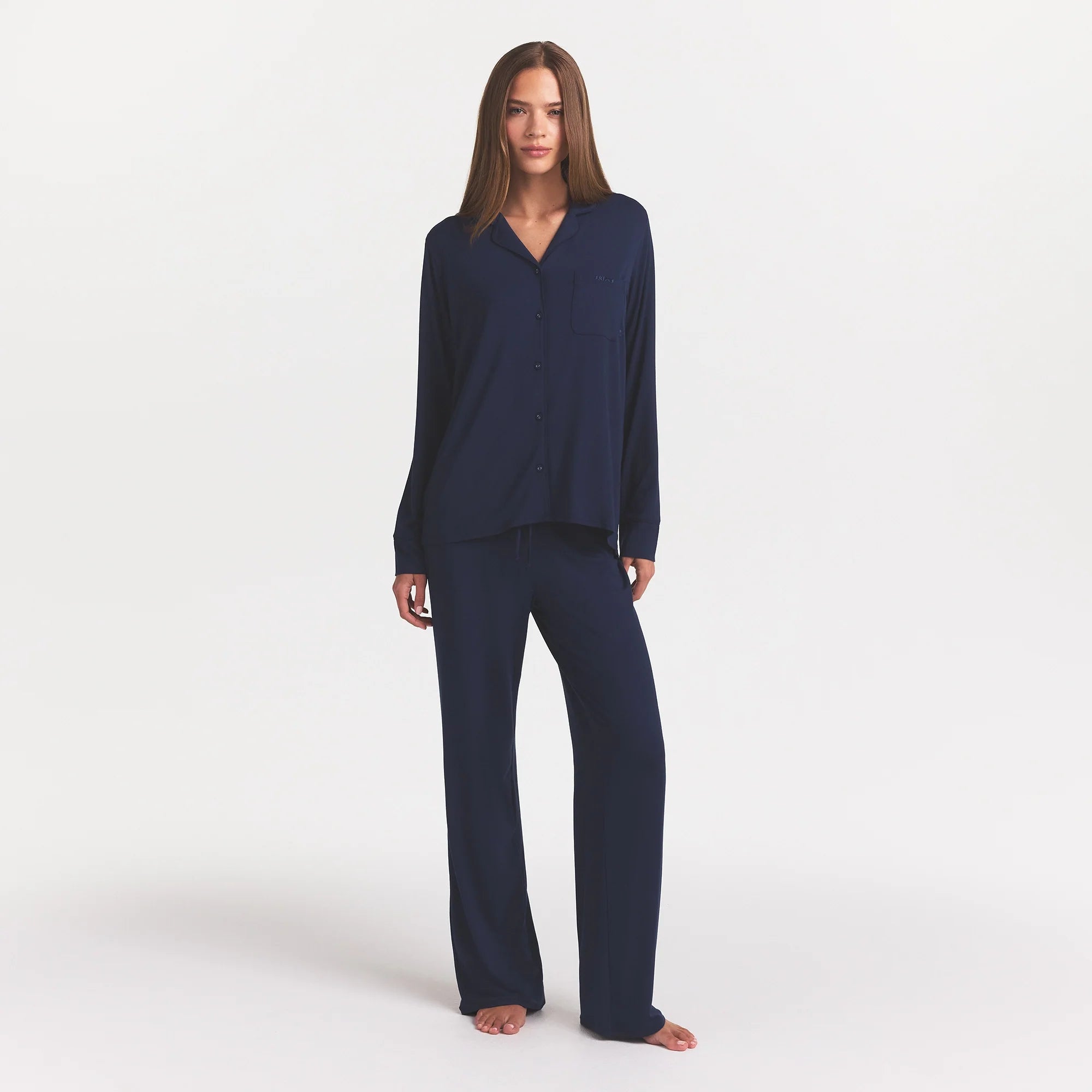 SKIMS SLEEP LONG SLEEVE BUTTON UP SET | NAVY ON A MODEL FRONT VIEW @ | FOCUS: 0.0, 1.0, 0.9