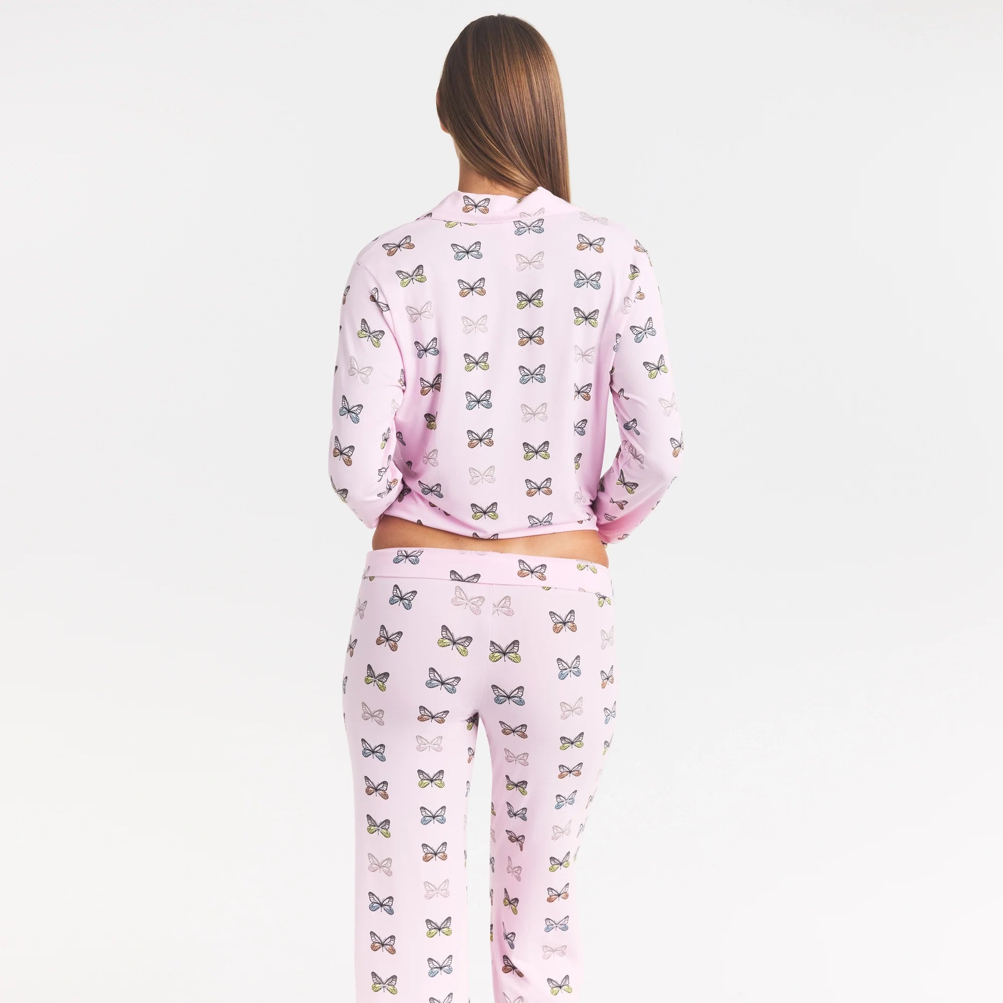 SKIMS SLEEP LONG SLEEVE BUTTON UP SET | PEONY BUTTERFLY PRINT ON A MODEL SIDE VIEW @ | FOCUS: 0.0, 1.0, 0.9