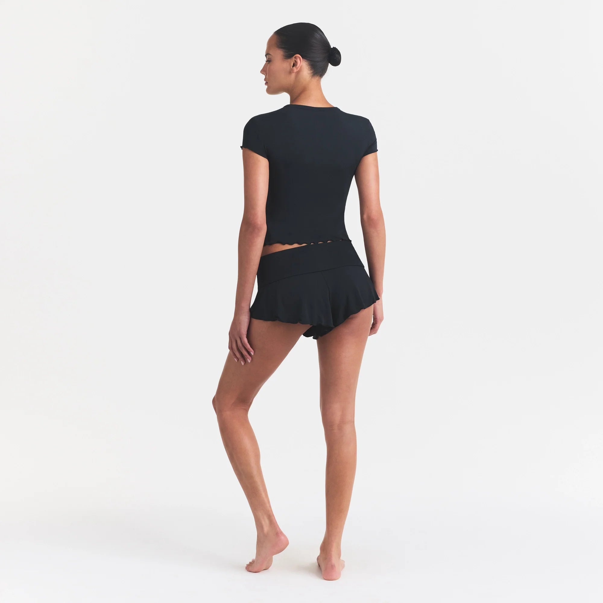 SKIMS SLEEP HENLEY AND FOLDOVER SHORT SET | ONYX ON A MODEL FRONT VIEW @ | FOCUS: 0.0, 1.0, 0.9