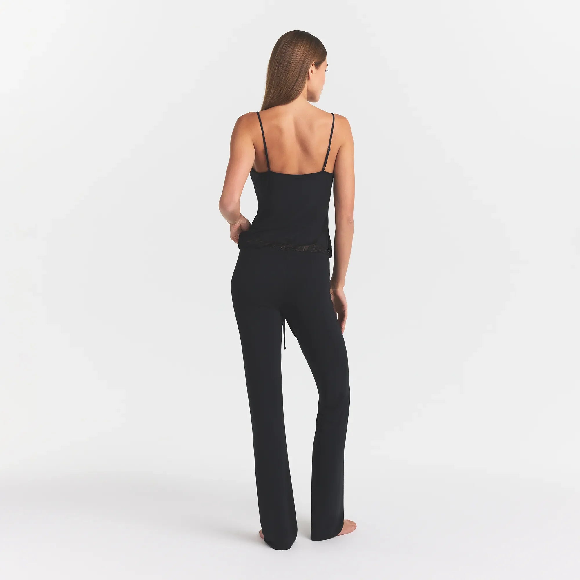 SKIMS SLEEP LACE CAMI AND PANT SET | ONYX ON A MODEL BACK VIEW @ | FOCUS: 0.0, 1.0, 0.9
