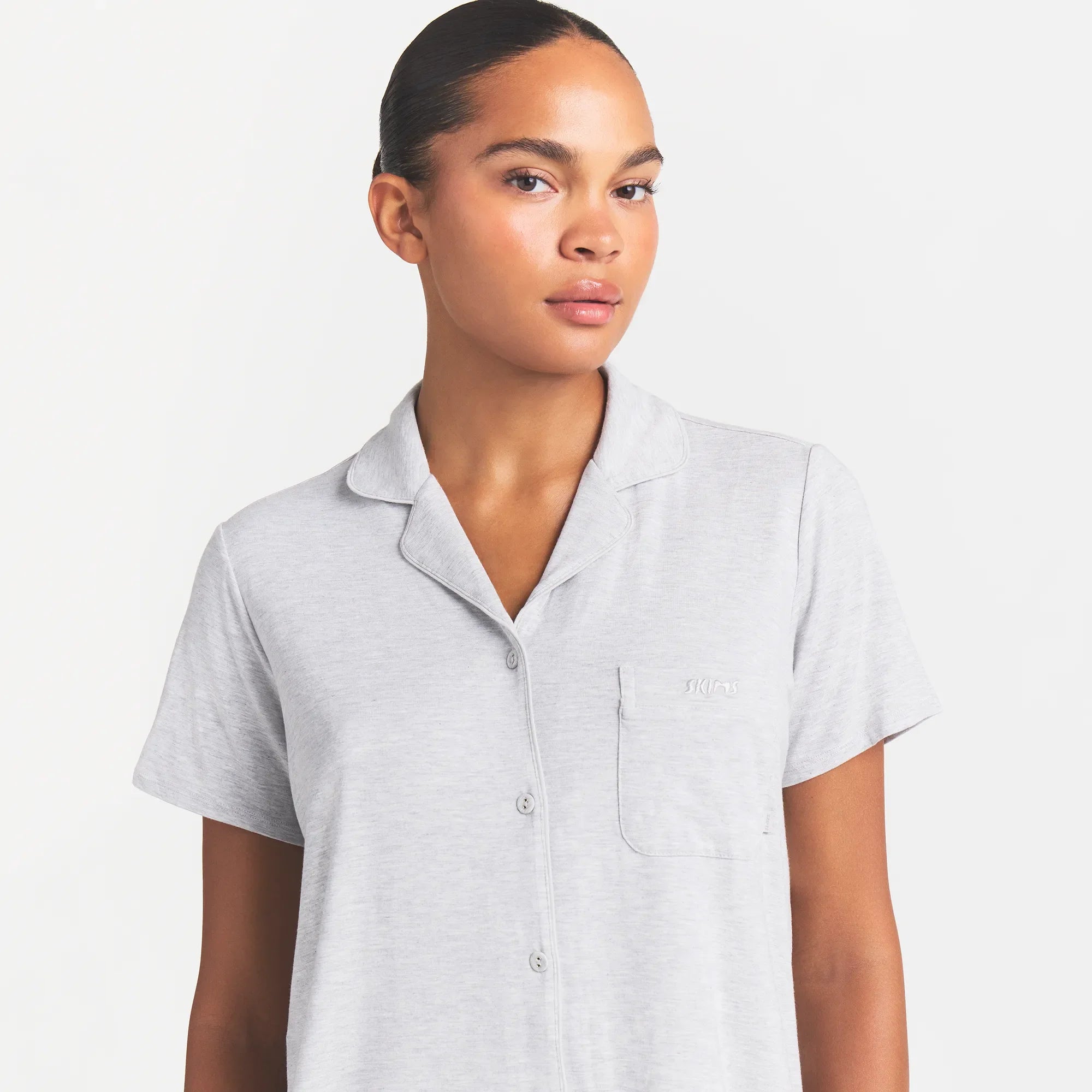 SKIMS SLEEP SHORT SLEEVE BUTTON UP SET | LIGHT HEATHER GREY ON A MODEL FRONT VIEW